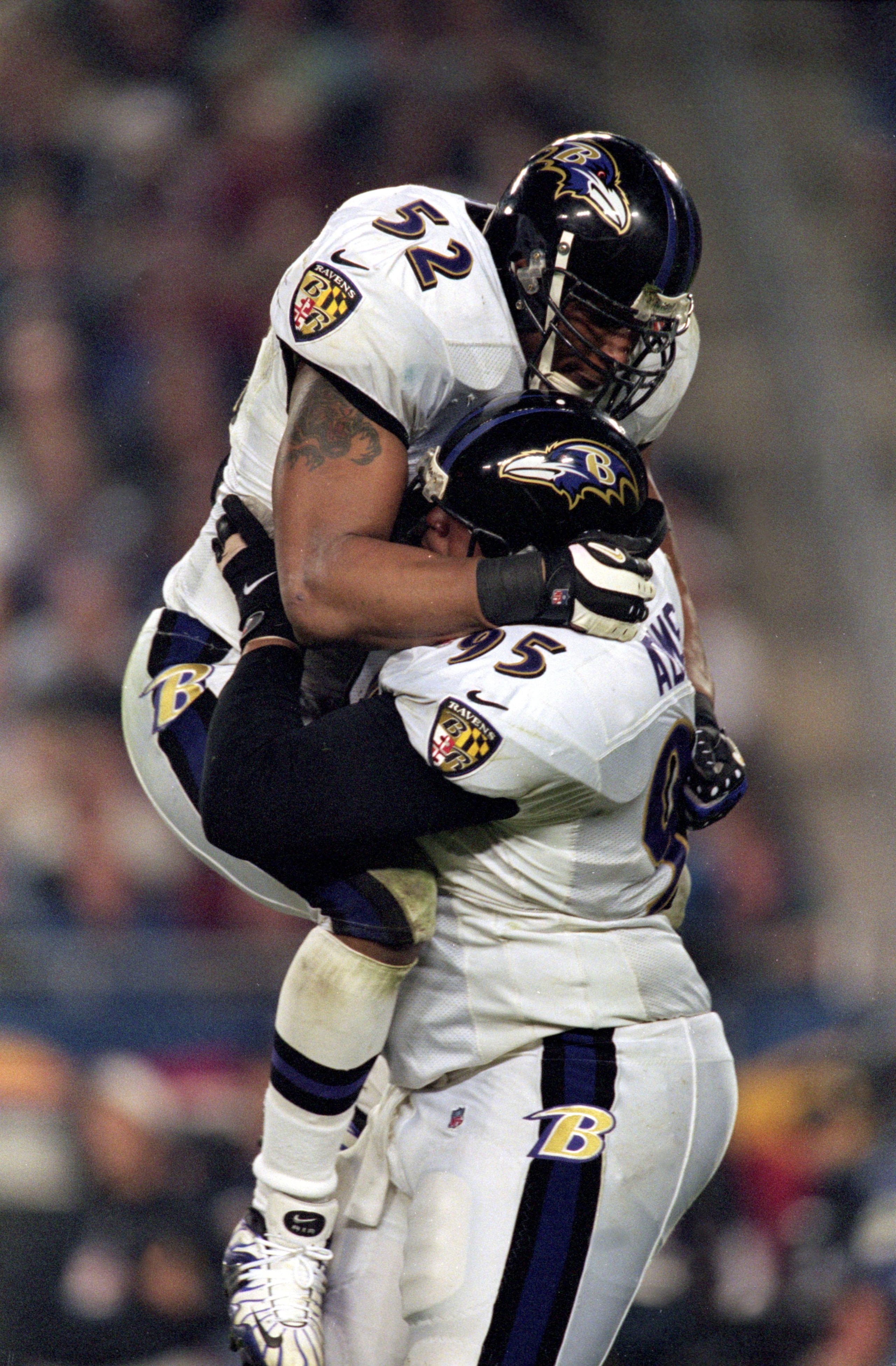 28 Jan 2001:  Ray Lewis #52 of the Baltimore Ravens leaps up and hugs teammate Sam Adams #95 after the Super Bowl XXXV Game against the New York Giants at the Raymond James Stadium in Tampa, Florida. The Ravens defeated the Giants 34-7.Mandatory Credit: A