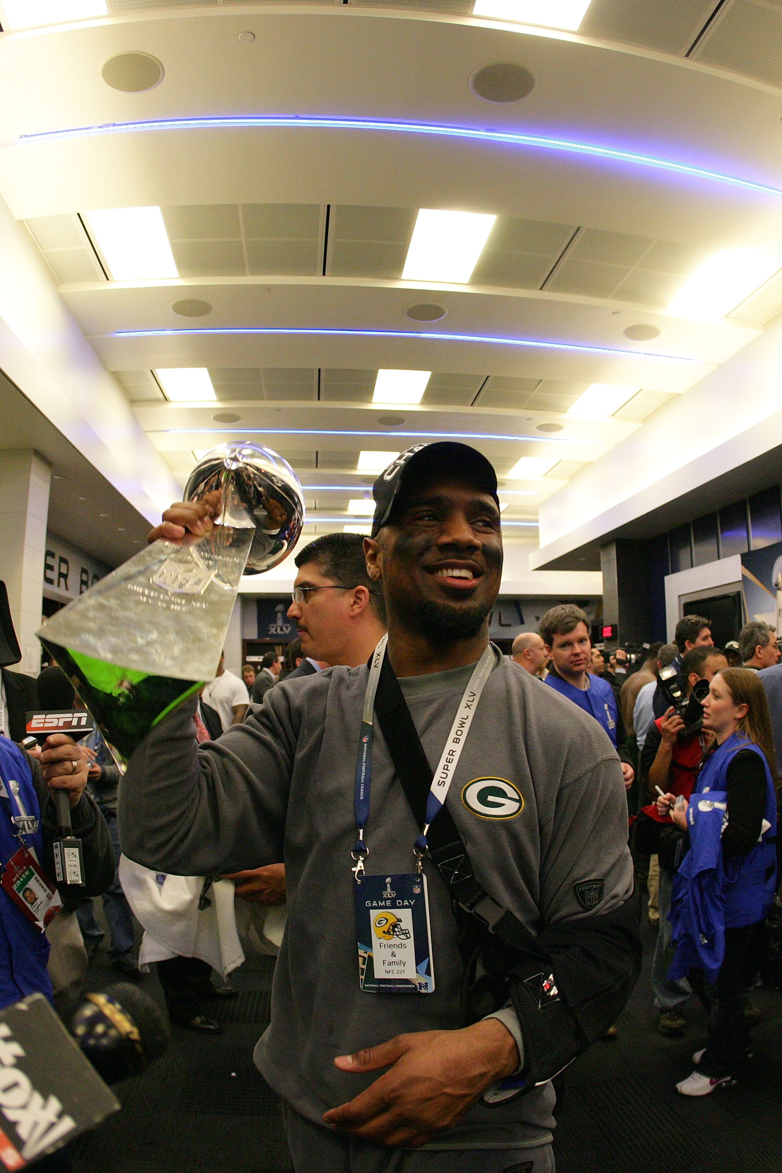 ARLINGTON, TX - FEBRUARY 06: Charles Woodson #21 of the Green Bay Packers celebrates in the locker room with the Vince Lombardi Trophy after winning Super Bowl XLV 31-25 against the Pittsburgh Steelers at Cowboys Stadium on February 6, 2011 in Arlington,