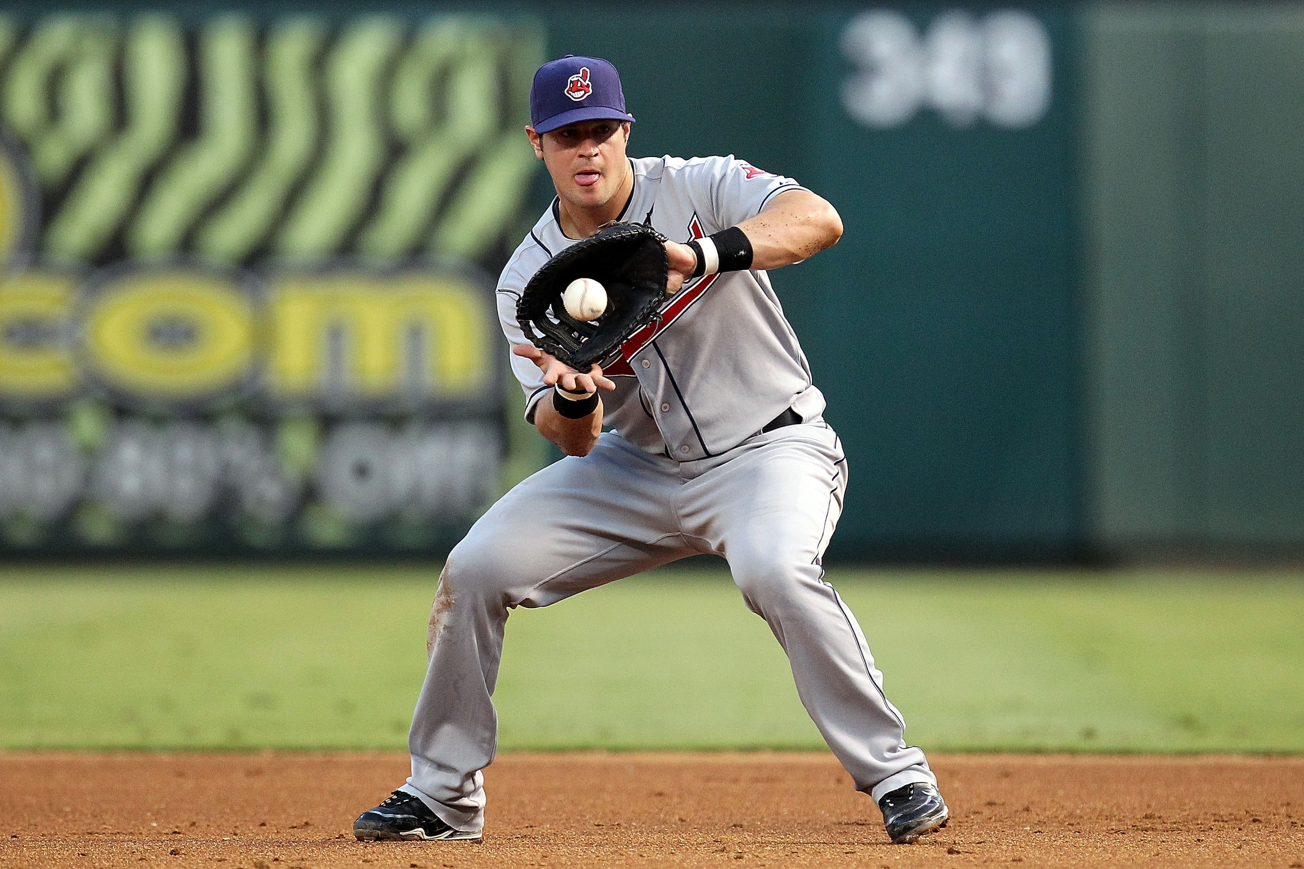 ARLINGTON, TX - JULY 05:  First baseman Matt LaPorta #7 of the Cleveland Indians fields an out against Michael Young of the Texas Rangers on July 5, 2010 at Rangers Ballpark in Arlington, Texas.  (Photo by Ronald Martinez/Getty Images)