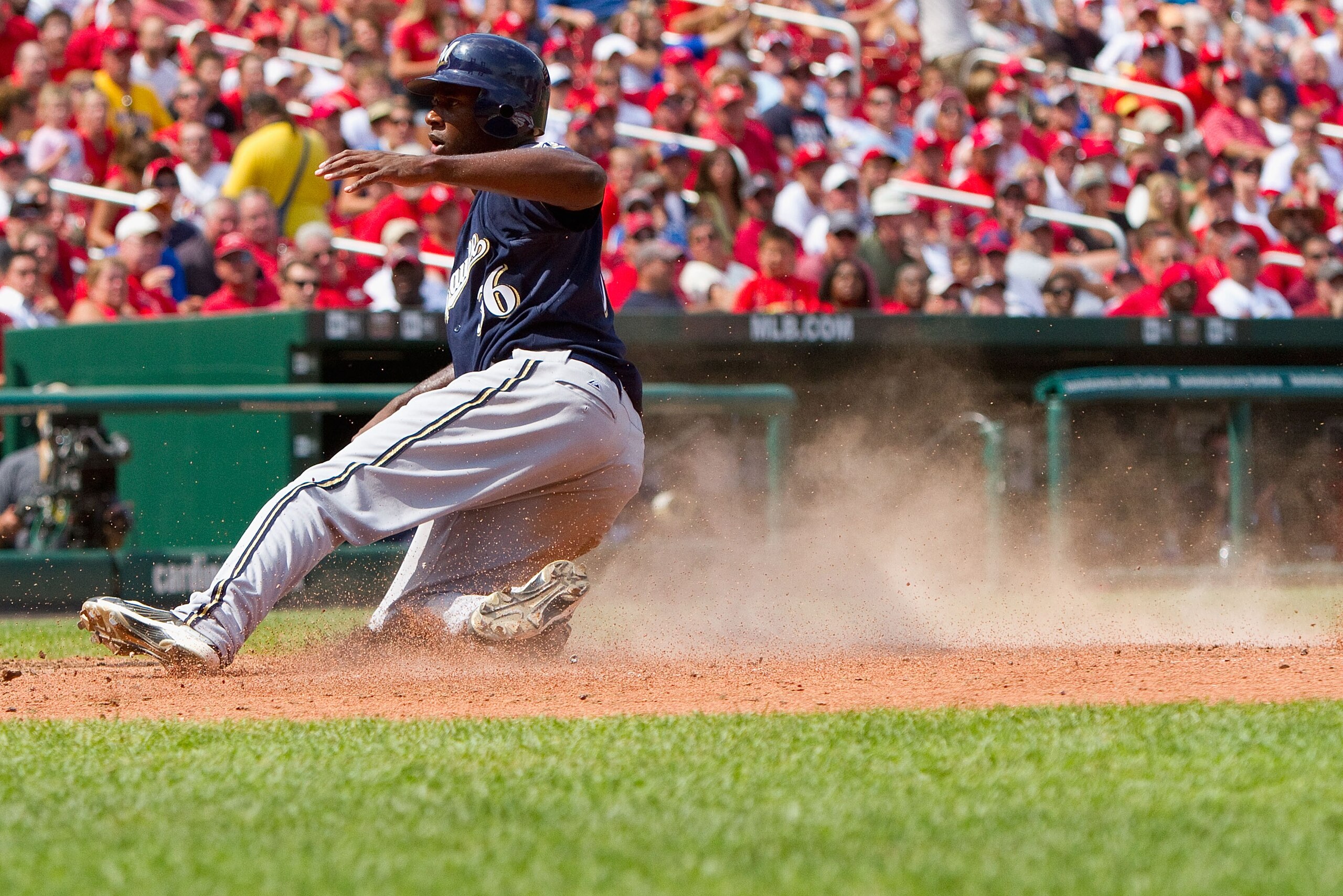 ST. LOUIS - AUGUST 18: Lorenzo Cain #36 of the Milwaukee Brewers scores a run against the St. Louis Cardinals at Busch Stadium on August 18, 2010 in St. Louis, Missouri.  The Brewers beat the Cardinals 3-2.  (Photo by Dilip Vishwanat/Getty Images)