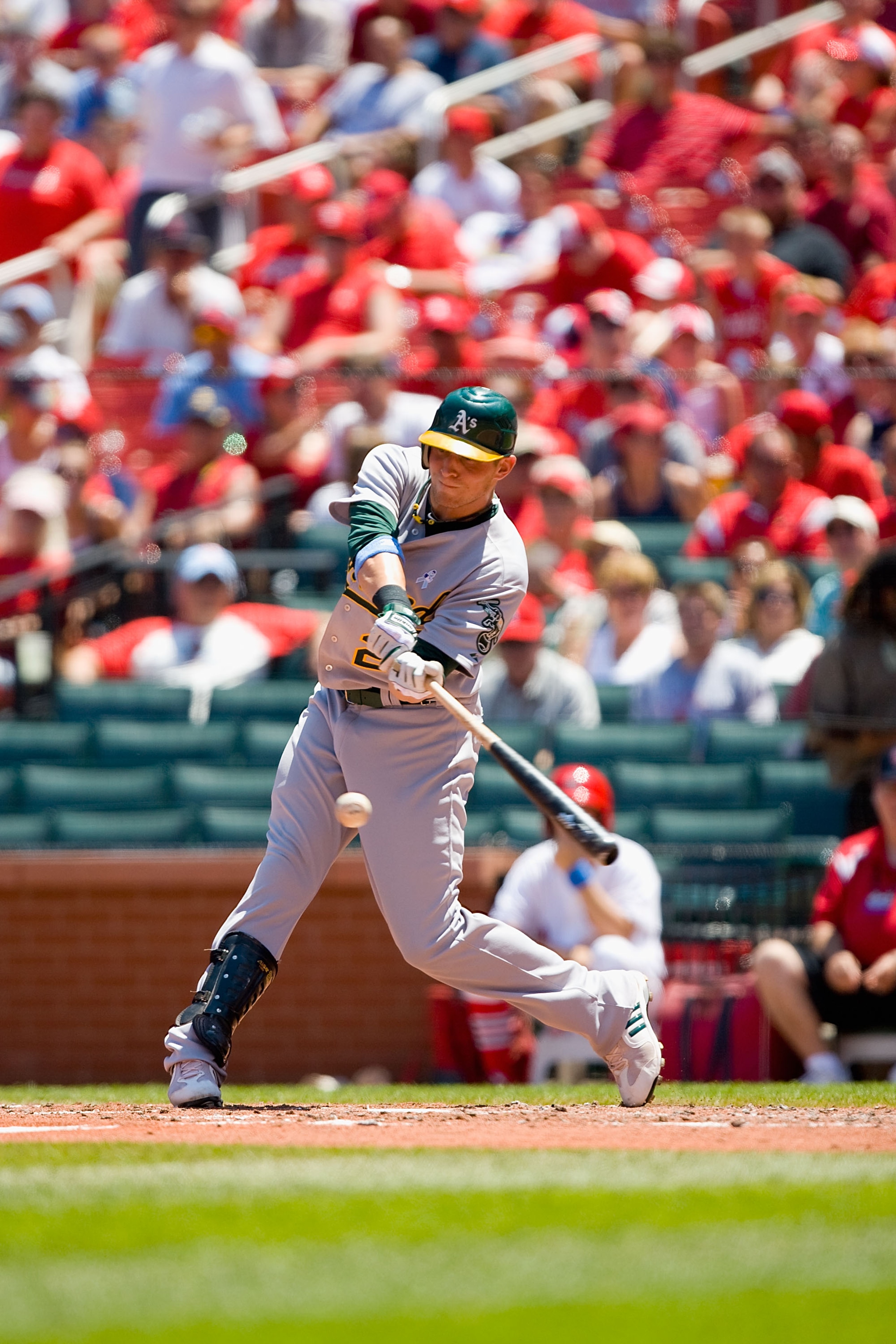 ST. LOUIS - JUNE 20: Ryan Sweeney #21 of the Oakland Athletics looks on from the dugout against the St. Louis Cardinals at Busch Stadium on June 20, 2010 in St. Louis, Missouri.  (Photo by Dilip Vishwanat/Getty Images)