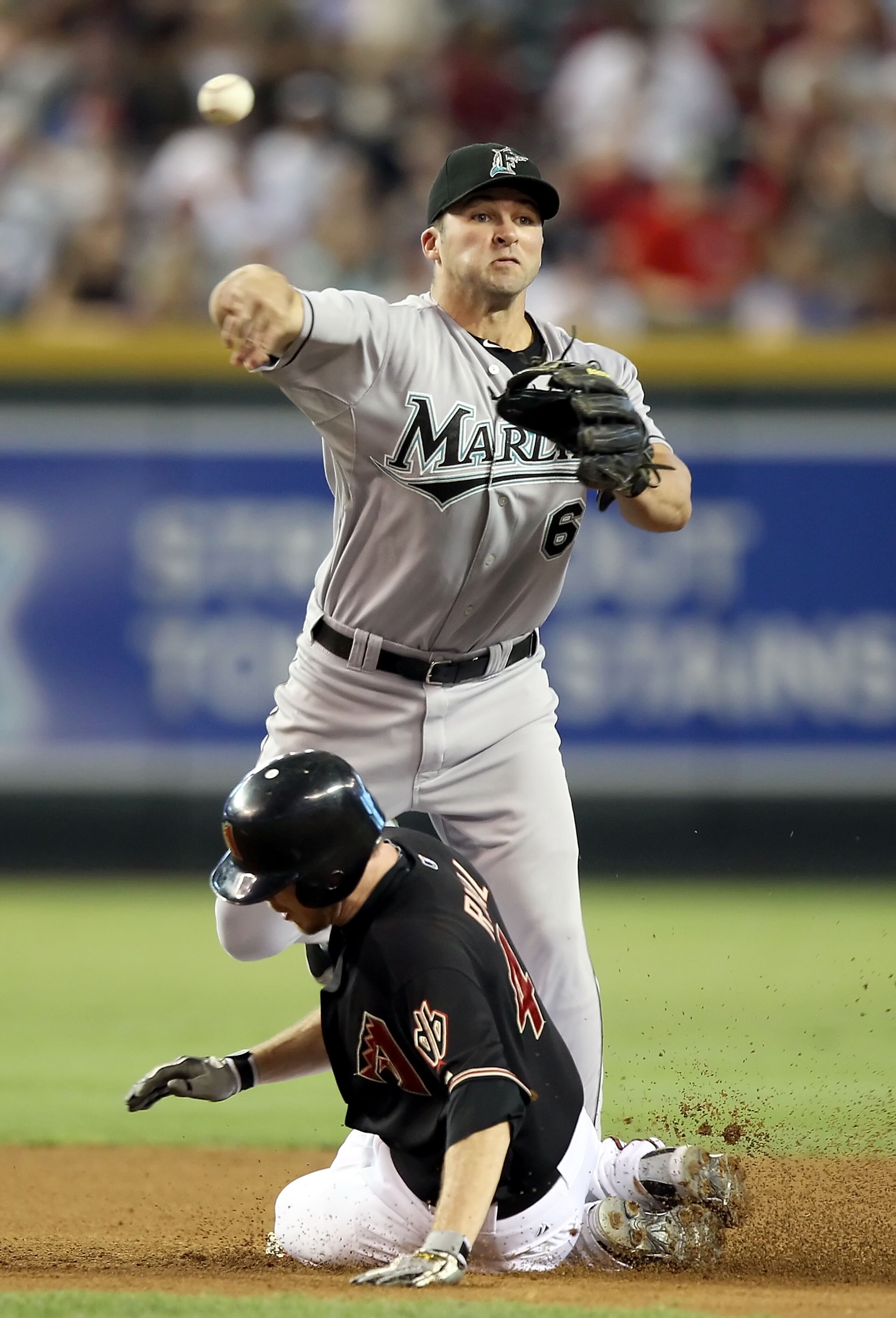 PHOENIX - JULY 10:  Infielder Dan Uggla #6 of the Florida Marlins throws over the sliding Rusty Ryal #4 of the Arizona Diamondbacks to complete a double play during the second inning of the Major League Baseball game at Chase Field on July 10, 2010 in Pho