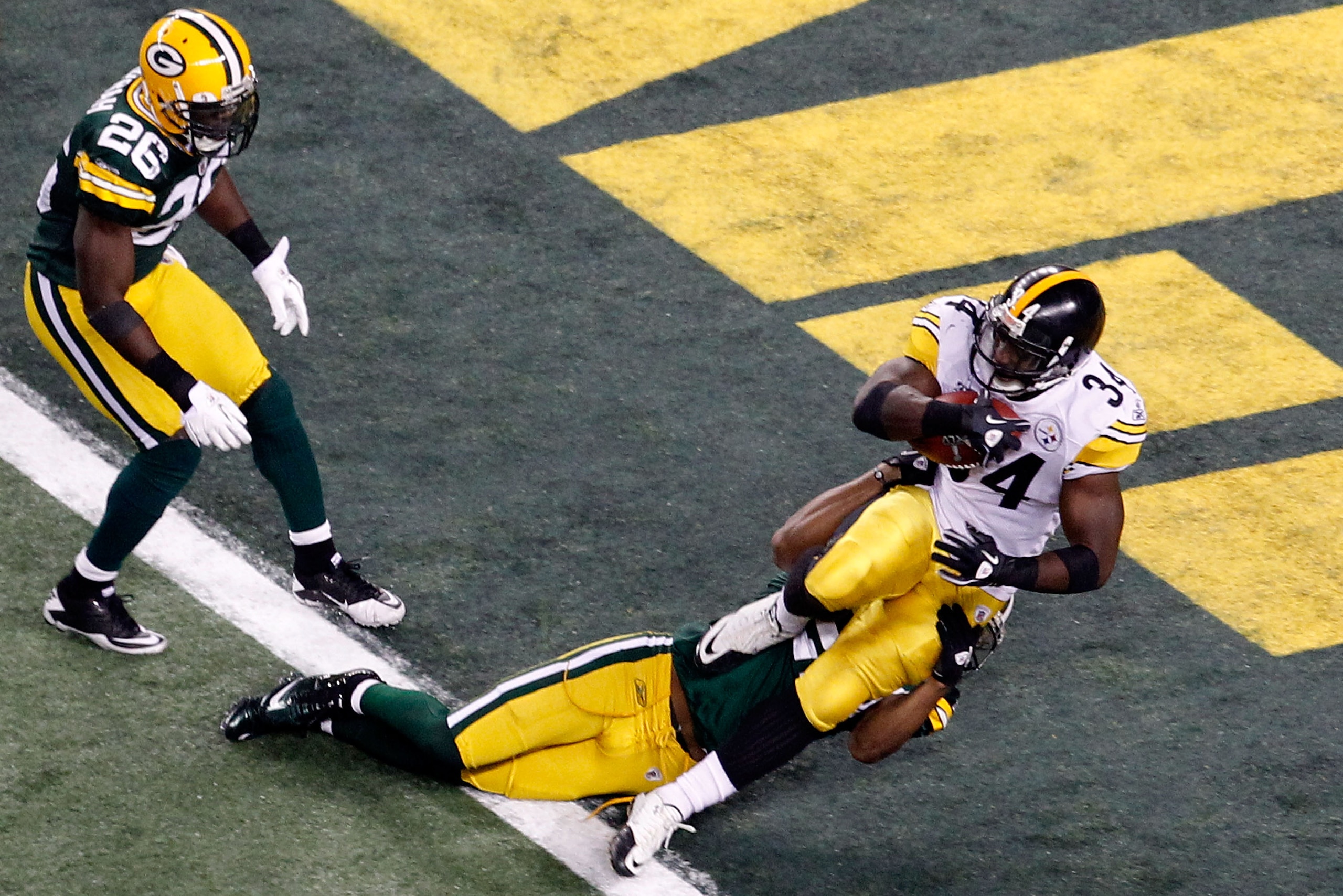 ARLINGTON, TX - FEBRUARY 06:  Rashard Mendenhall #34 of the Pittsburgh Steelers runs for an eight yard touchdown against the tackle of Pat Lee #22 of the Green Bay Packers in the third quarter of Super Bowl XLV at Cowboys Stadium on February 6, 2011 in Ar