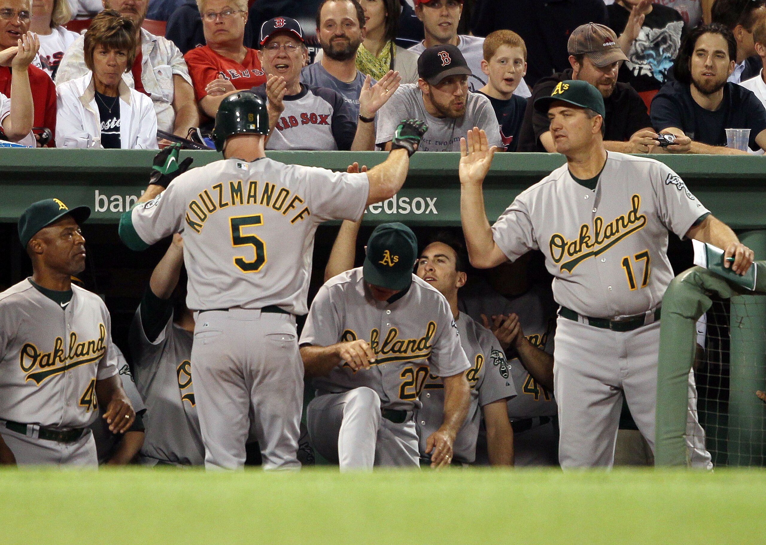 BOSTON - JUNE 02:  Kevin Kouzmanoff #5 of the Oakland Athletics is congratulated by manager Bob Geren #17 after Kouzmanoff hit a solo home run in the ninth inning against the Boston Red Sox on June 2, 2010 at Fenway Park in Boston, Massachusetts.  The Red