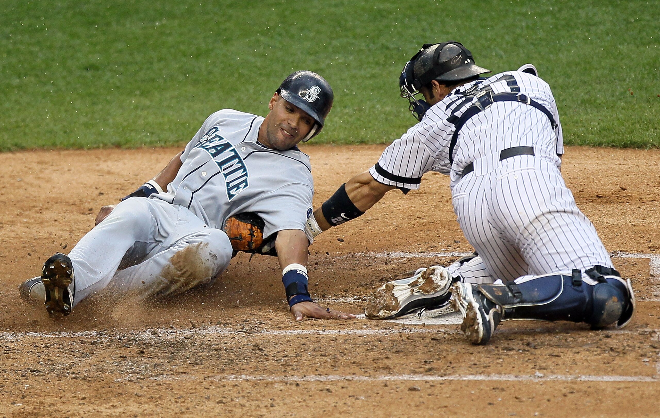 NEW YORK - AUGUST 22: Franklin Gutierrez #21 of the Seattle Mariners is out at the plate on the tag from Jorge Posada #20 of the New York Yankees during the fifth inning on August 22, 2010 at Yankee Stadium in the Bronx borough of New York City. (Photo NEW YORK - AUGUST 22: Franklin Gutierrez #21 of the Seattle Mariners is out at the plate on the tag from Jorge Posada #20 of the New York Yankees during the fifth inning on August 22, 2010 at Yankee Stadium in the Bronx borough of New York City. (Photo