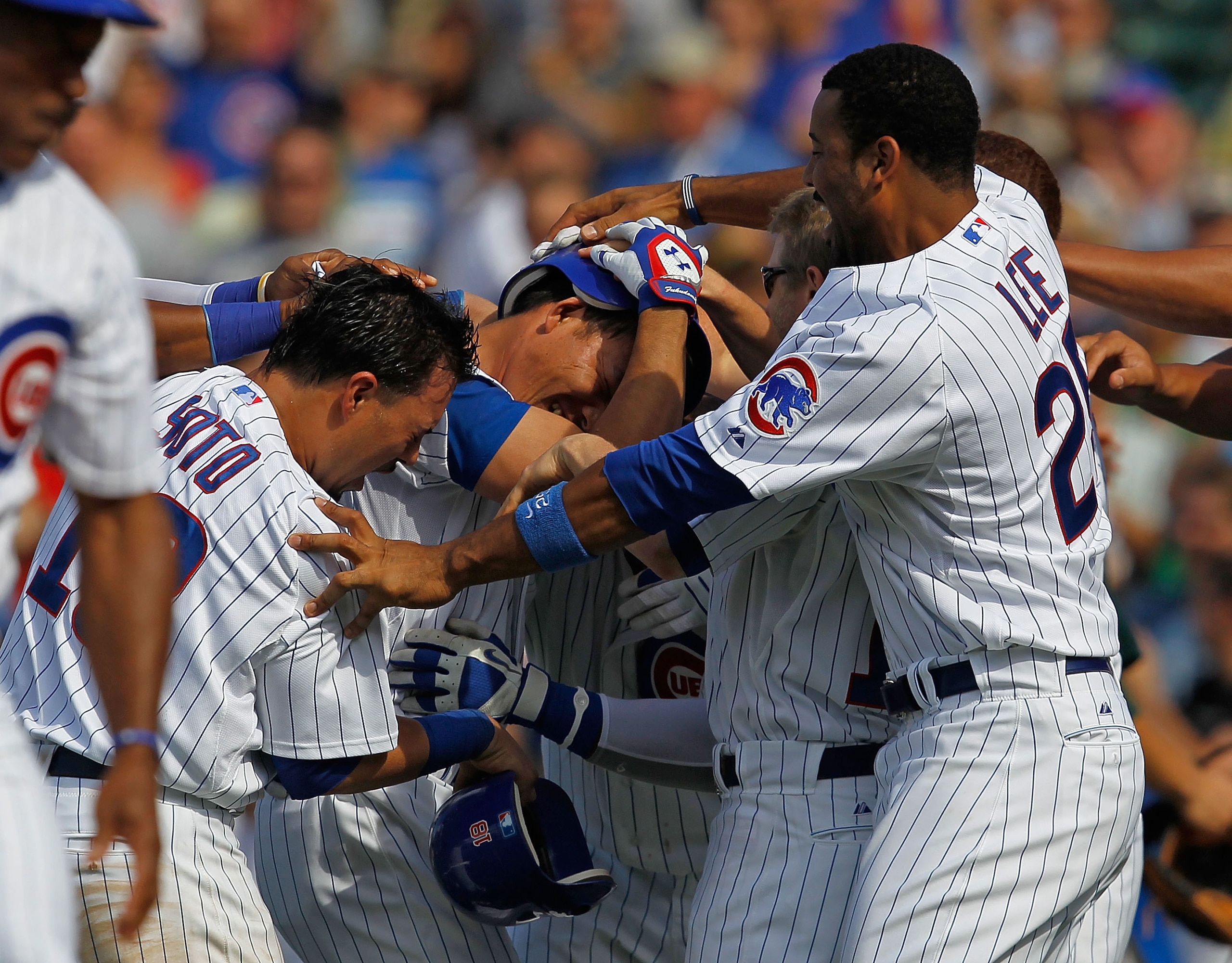 CHICAGO - JUNE 17: Kosuke Fukudome #1 of the Chicago Cubs is mobbed by teammates including Geovany Soto #18 and Derrick Lee #25 after getting the game-winning hit in the bottom of the 9th inning against the Oakland Athletics at Wrigley Field on June 17, 2