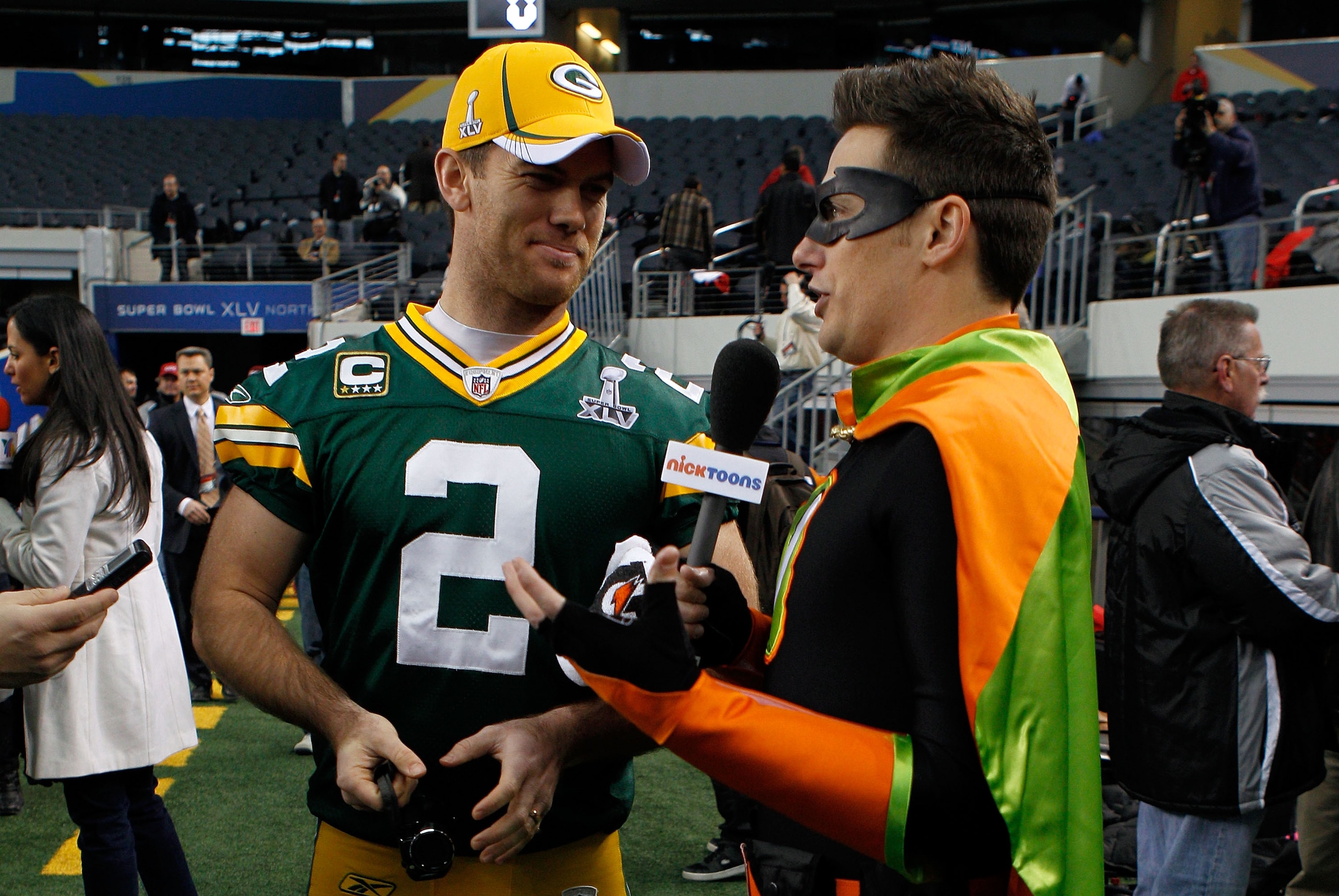 ARLINGTON, TX - FEBRUARY 01: Mason Crosby #2 of the Green Bay Packers is interviewed by a member of the media dresses a superhero during Super Bowl XLV Media Day ahead of Super Bowl XLV at Cowboys Stadium on February 1, 2011 in Arlington, Texas. The Pitt ARLINGTON, TX - FEBRUARY 01: Mason Crosby #2 of the Green Bay Packers is interviewed by a member of the media dresses a superhero during Super Bowl XLV Media Day ahead of Super Bowl XLV at Cowboys Stadium on February 1, 2011 in Arlington, Texas. The Pitt