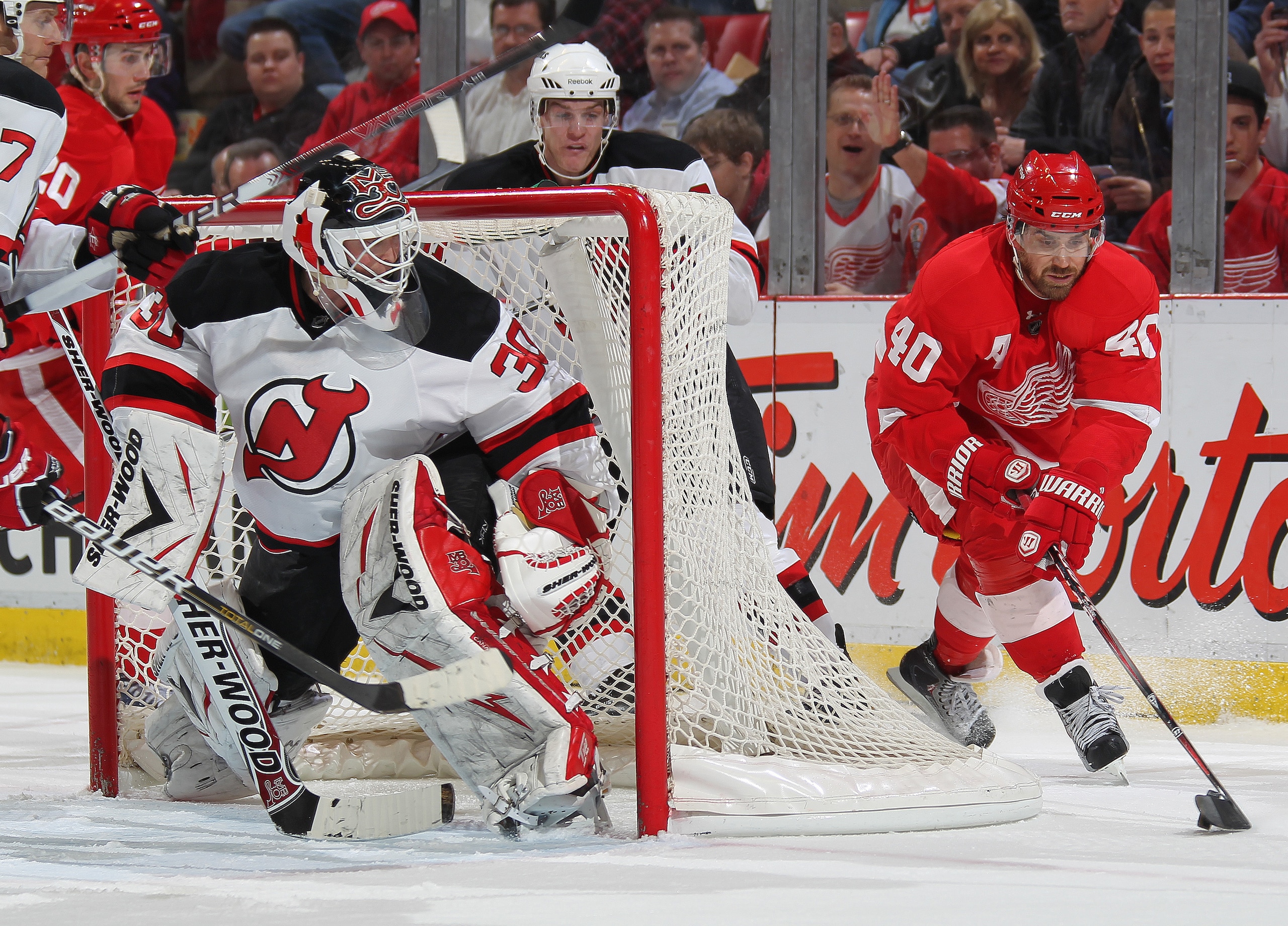 DETROIT, MI - JANUARY 26: Henrik Zetterberg #40 of the Detroit Red Wings swings around the net for a shot on Martin Brodeur #30 of the New Jersey Devils in a game on January 26, 2011 at the Joe Louis Arena in Detroit, Michigan. The Wings defeated the Dev DETROIT, MI - JANUARY 26: Henrik Zetterberg #40 of the Detroit Red Wings swings around the net for a shot on Martin Brodeur #30 of the New Jersey Devils in a game on January 26, 2011 at the Joe Louis Arena in Detroit, Michigan. The Wings defeated the Dev