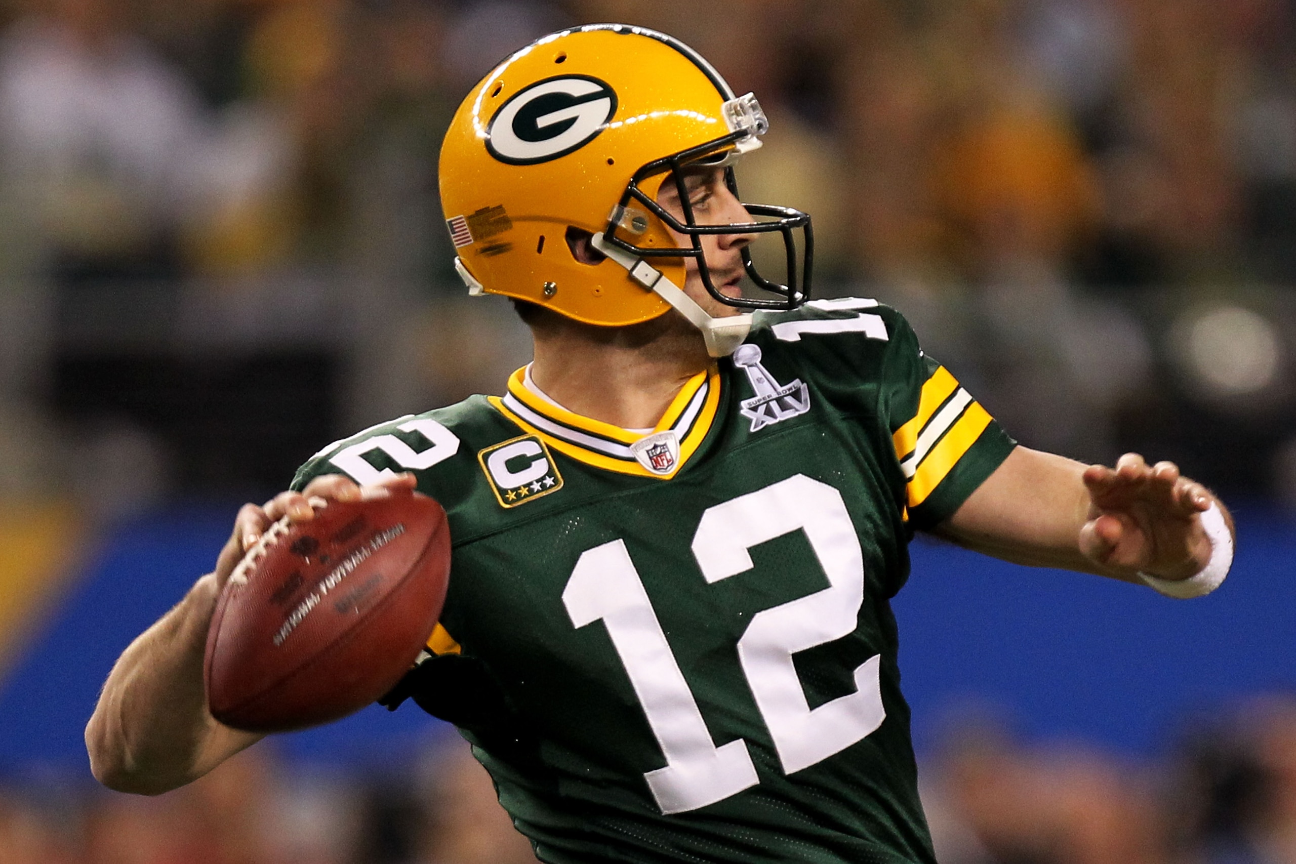 ARLINGTON, TX - FEBRUARY 06:  Aaron Rodgers #12 of the Green Bay Packers drops back against the Pittsburgh Steelers during the first quarter of Super Bowl XLV at Cowboys Stadium on February 6, 2011 in Arlington, Texas.  (Photo by Ronald Martinez/Getty Ima