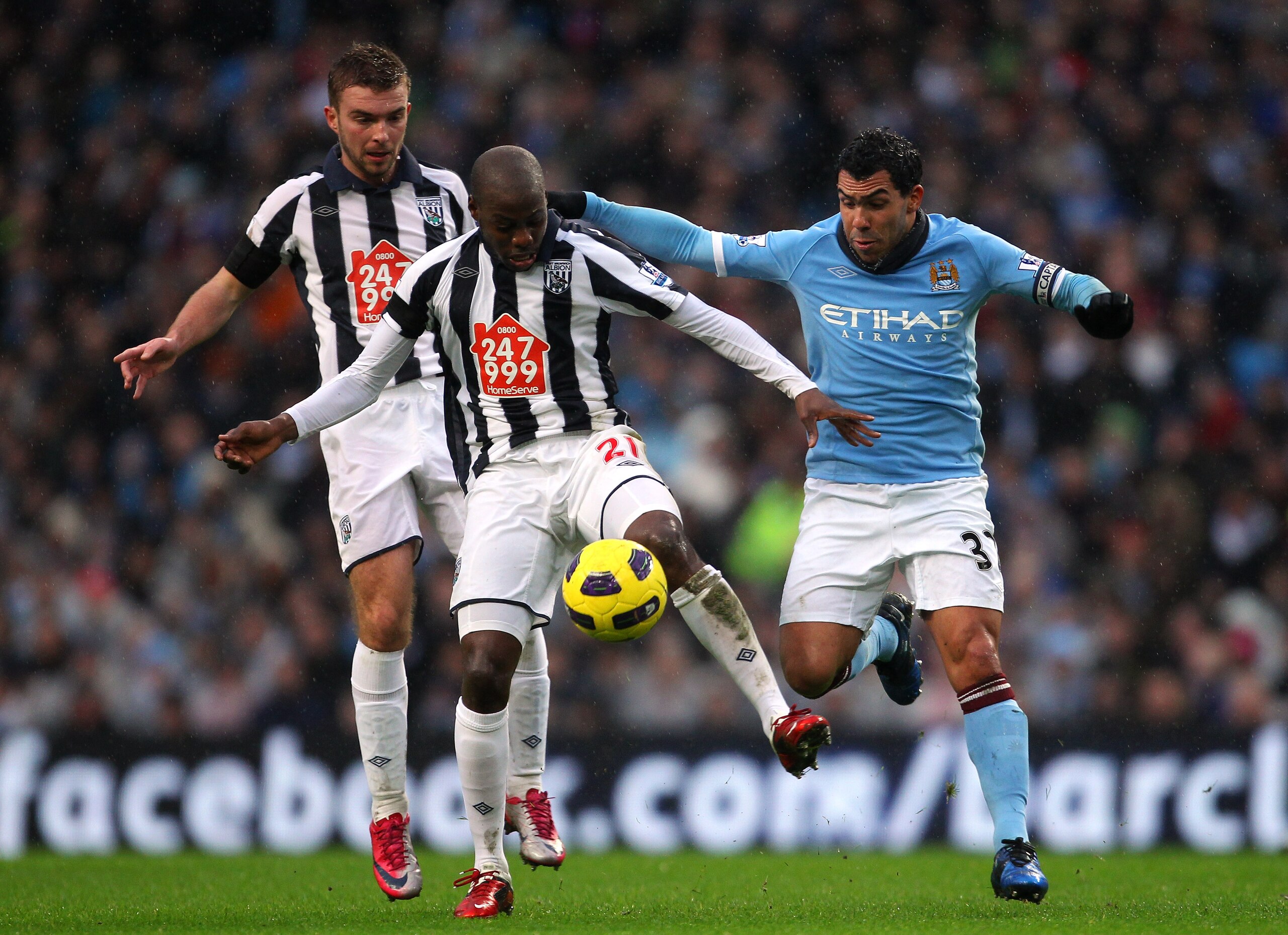 MANCHESTER, ENGLAND - FEBRUARY 05:  Carlos Tevez of Manchester City puts Youssuf Mulumbu of West Bromwich Albion under pressure during the Barclays Premier League match between Manchester City and West Bromwich Albion at the City of Manchester Stadium on