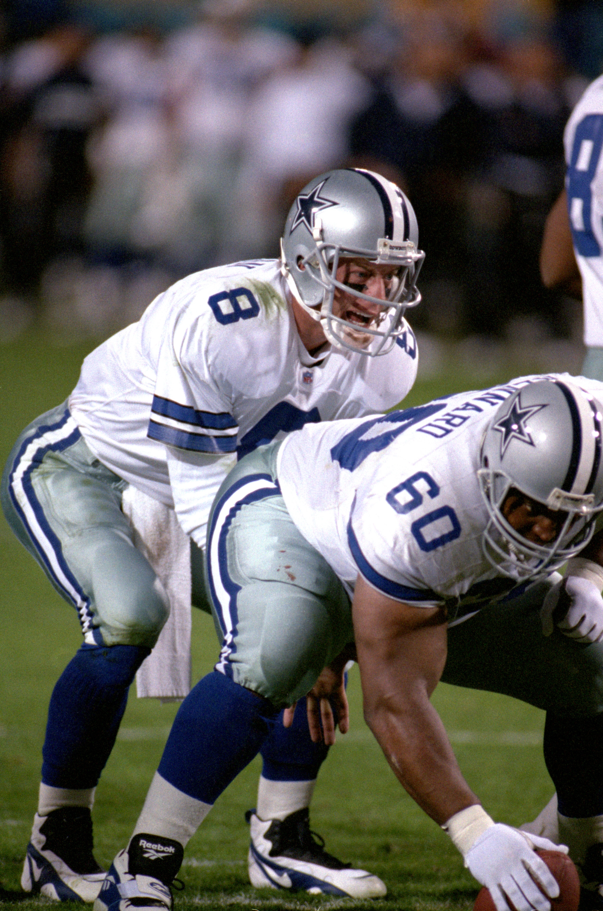 TEMPE, AZ - JANUARY 28:  Quarterback Troy Aikman #8 of the Dallas Cowboys calls a play behind center Derek Kennard #60 during Super Bowl XXX against the Pittsburgh Steelers at Sun Devil Stadium on January 28, 1996 in Tempe, Arizona.  The Cowboys won 27-17