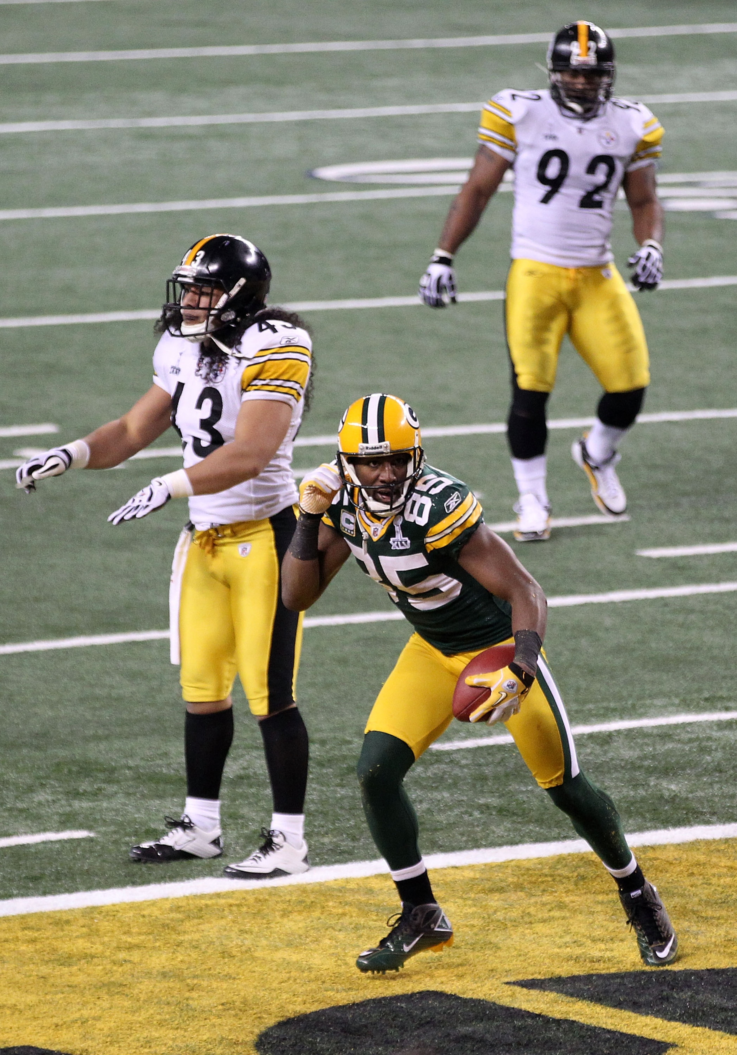 ARLINGTON, TX - FEBRUARY 06: Greg Jennings #85 of the Green Bay Packers celebrates after catching a 21 yard touchdown against Troy Polamalu #43 and James Harrison #92 of the Pittsburgh Steelers during Super Bowl XLV at Cowboys Stadium on February 6, 2011