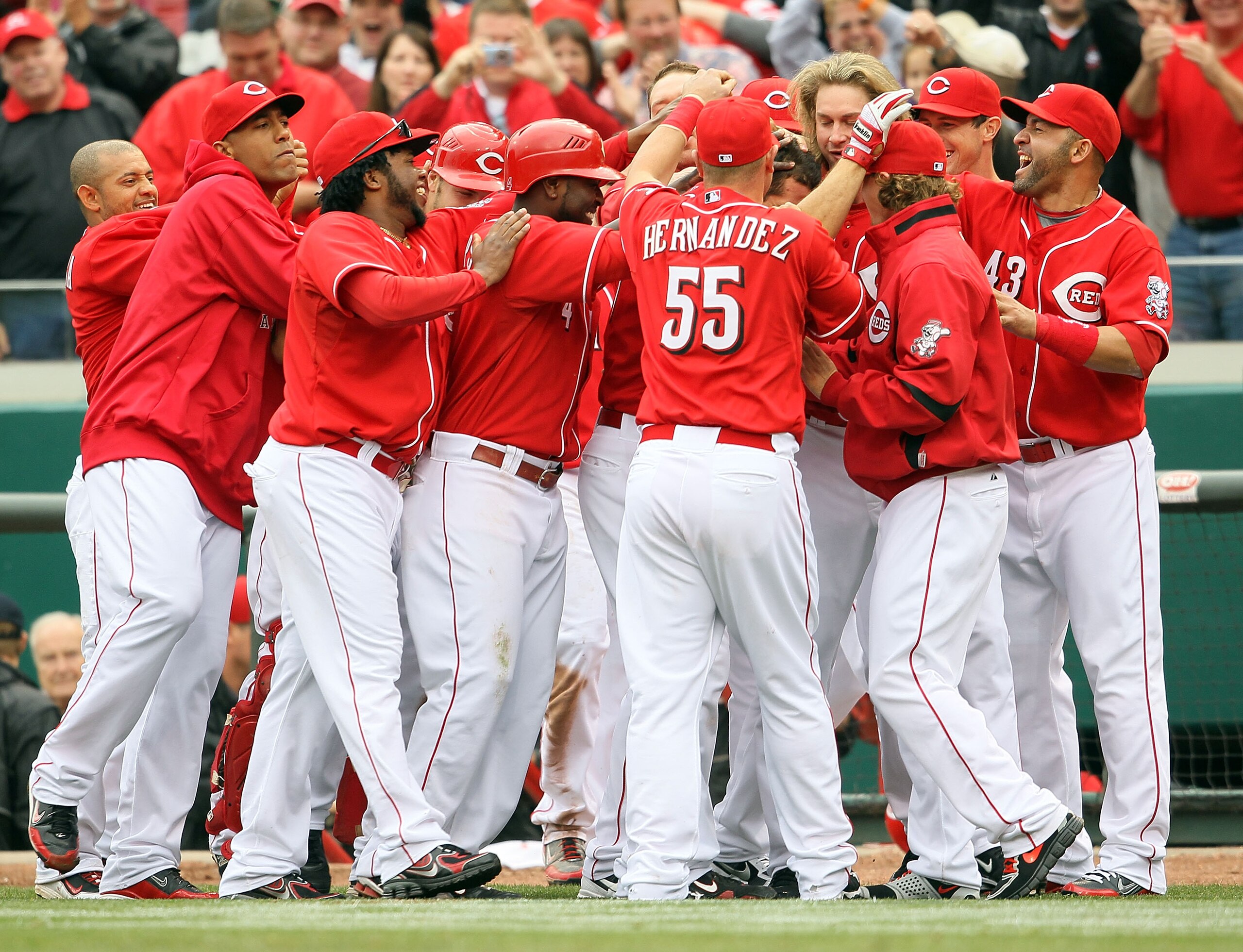 CINCINNATI - MAY 18:  Joey Votto #19 of the Cincinnati Reds is congratulated by teammates after a game winning hit in the bottom of the 9th inning during the game against the Milwaukee Brewers at Great American Ball Park on May 18, 2010 in Cincinnati, Ohi