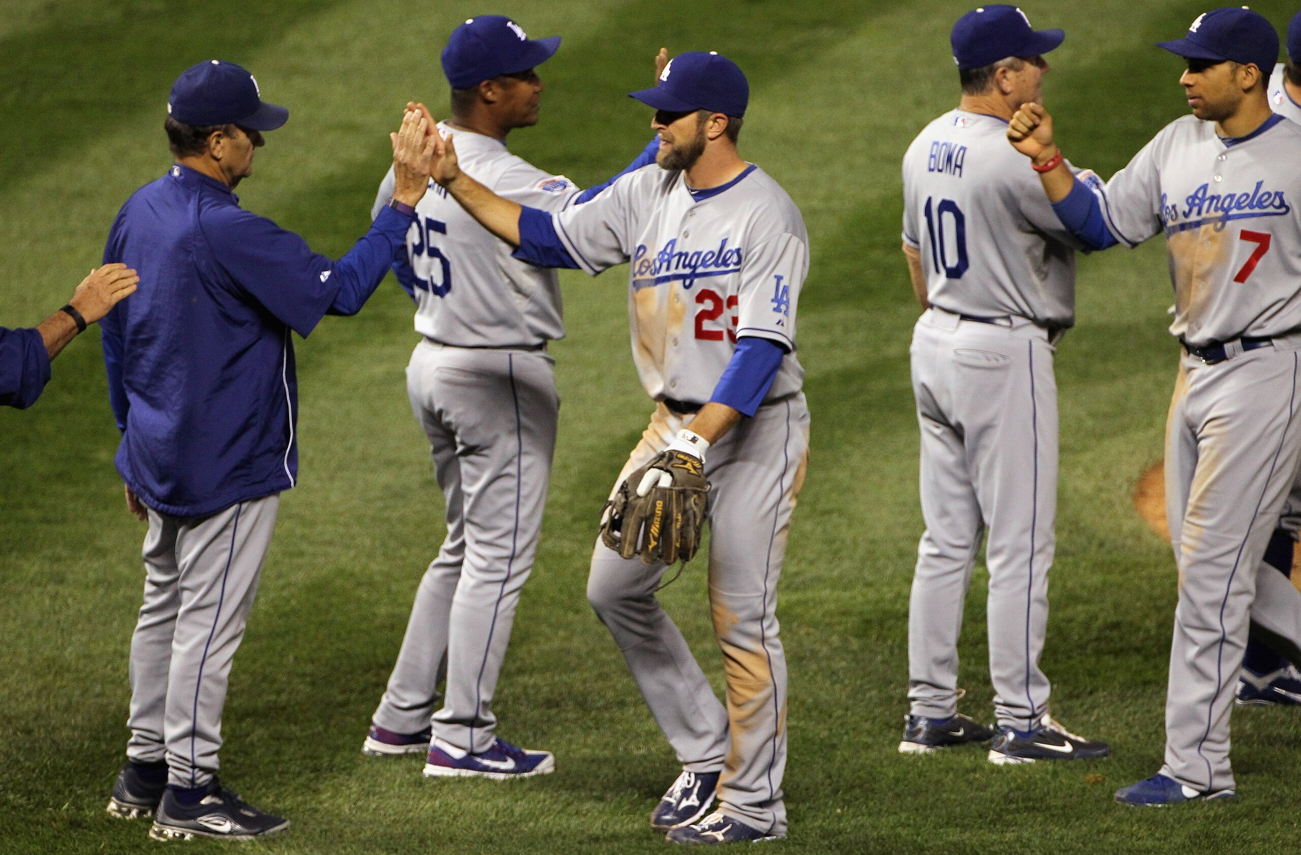DENVER - SEPTEMBER 27:  Manager Joe Torre (L)high fives Casey Blake #23 as the Los Angeles Dodgers celebrate their victory over the Colorado Rockies at Coors Field on September 25, 2010 in Denver, Colorado.The Dodgers defeated the Rockies 3-1.  (Photo by