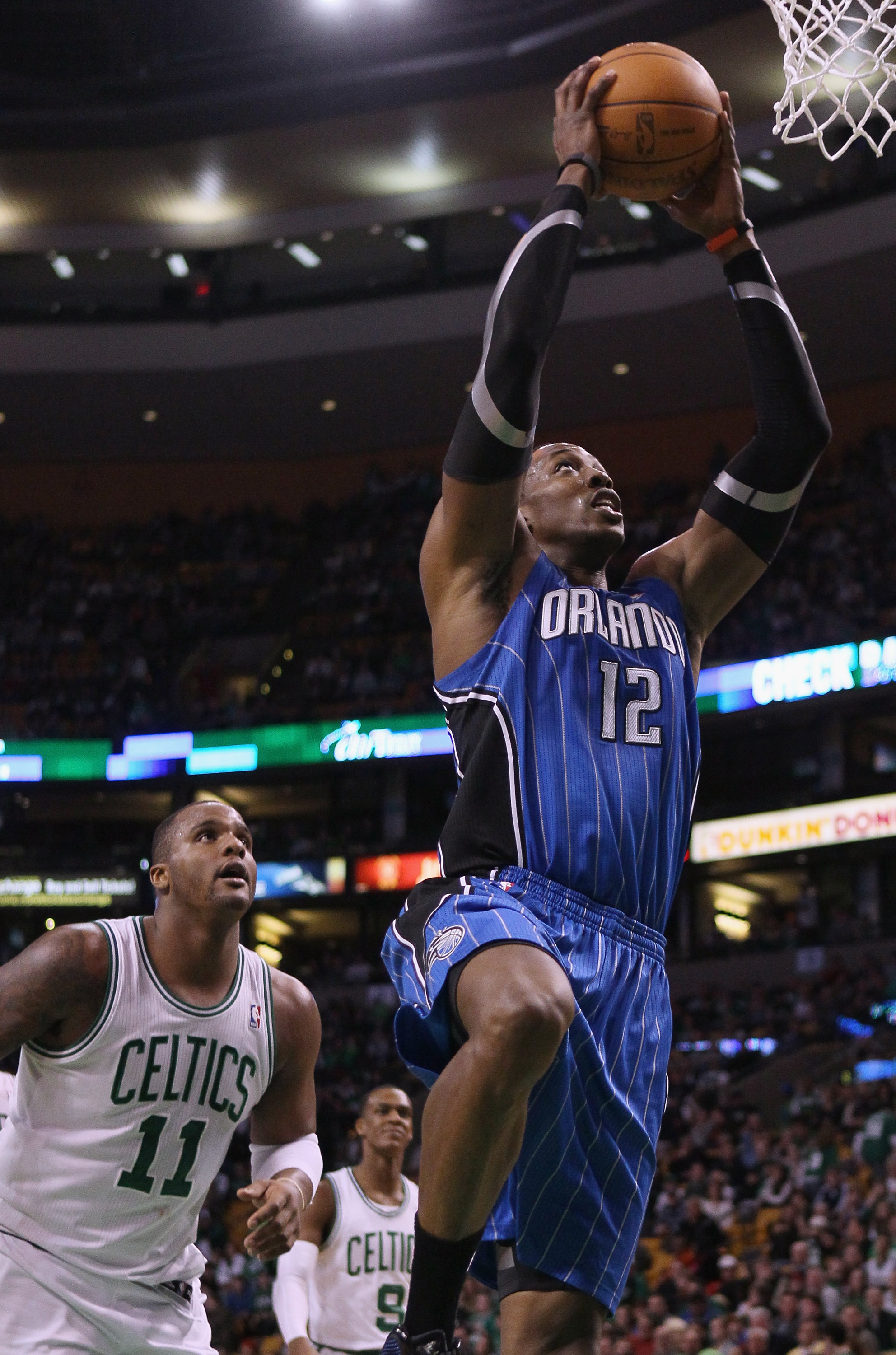 BOSTON, MA - FEBRUARY 06:  Dwight Howard #12 of the Orlando Magic takes a shot as Glen Davis #11 of the Boston Celtics defends on February 6, 2011 at the TD Garden in Boston, Massachusetts. The Celtics defeated the Magic 91-80. NOTE TO USER: User expressl