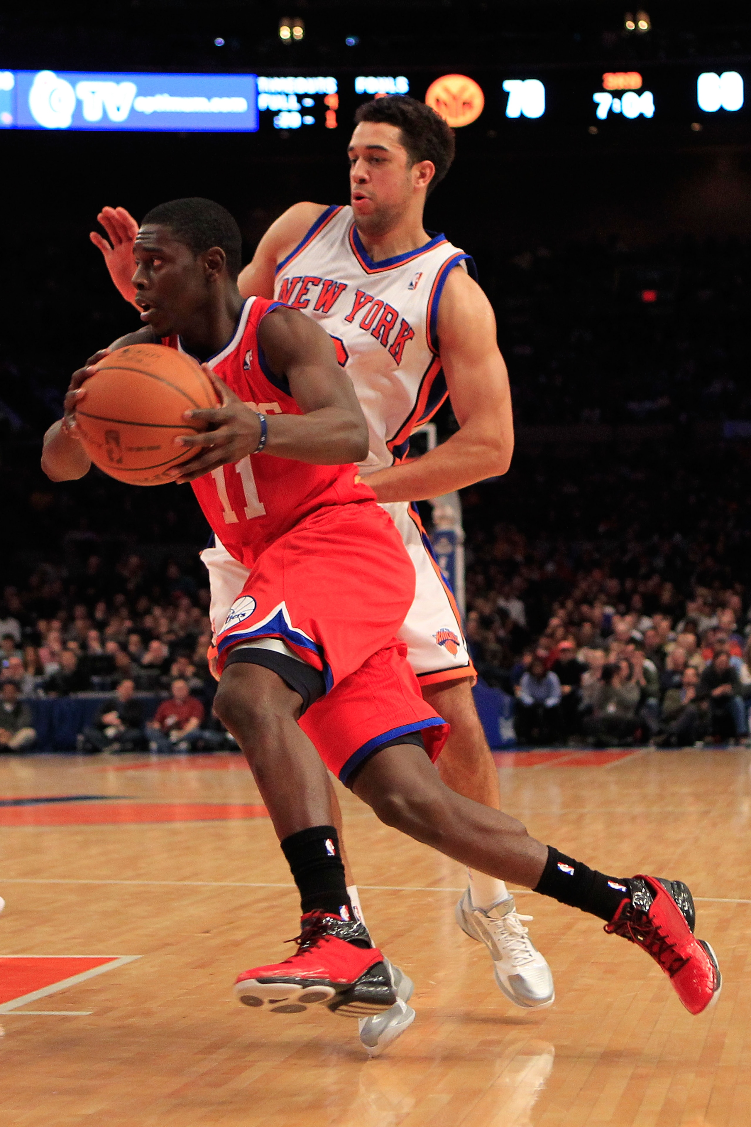 NEW YORK, NY - FEBRUARY 06: Jrue Holiday #11 of the Philadelphia 76ers drives past Landry Fields #6 of the New York Knicks at Madison Square Garden on February 6, 2011 in New York City. NOTE TO USER: User expressly acknowledges and agrees that, by downloa