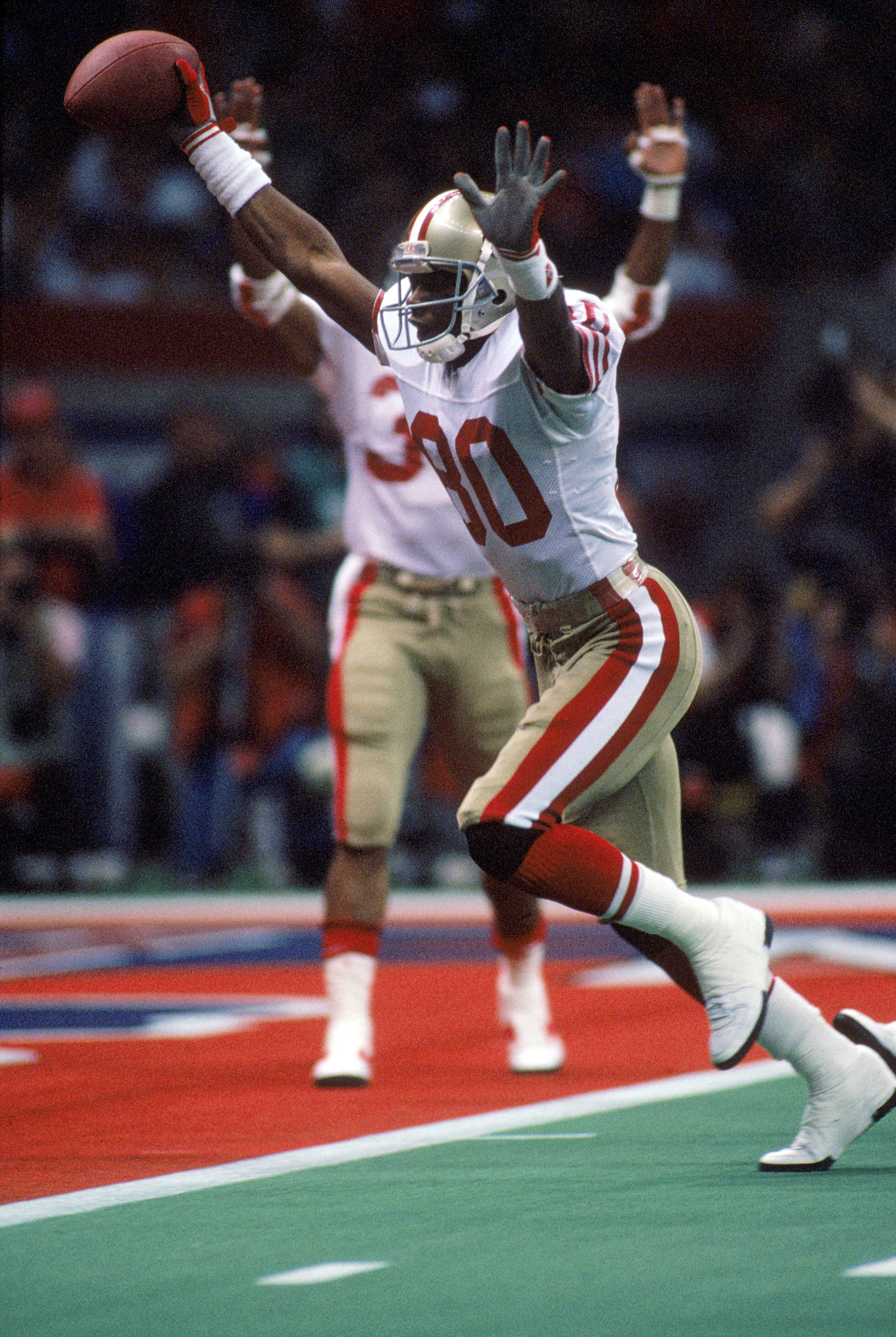 NEW ORLEANS - JANUARY 28:  Wide receiver Jerry Rice #80 of the San Francisco 49ers celebrates on his way to the end zone for a touchdown in Super Bowl XXIV against the Denver Broncos at Louisiana Superdome on January 28, 1990 in New Orleans, Louisiana.  T