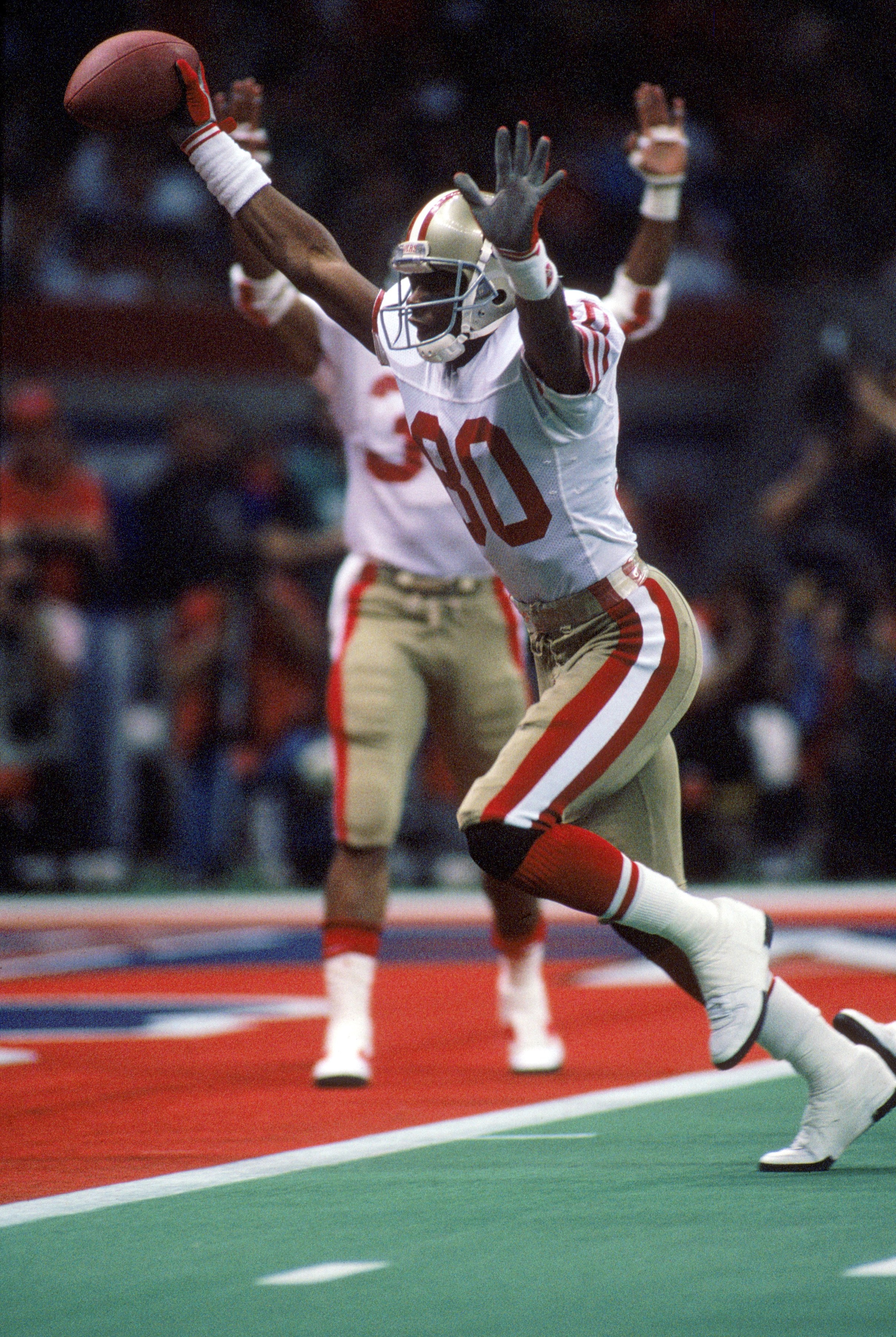 NEW ORLEANS - JANUARY 28: Wide receiver Jerry Rice #80 of the San Francisco 49ers celebrates on his way to the end zone for a touchdown in Super Bowl XXIV against the Denver Broncos at Louisiana Superdome on January 28, 1990 in New Orleans, Louisiana. T NEW ORLEANS - JANUARY 28: Wide receiver Jerry Rice #80 of the San Francisco 49ers celebrates on his way to the end zone for a touchdown in Super Bowl XXIV against the Denver Broncos at Louisiana Superdome on January 28, 1990 in New Orleans, Louisiana. T