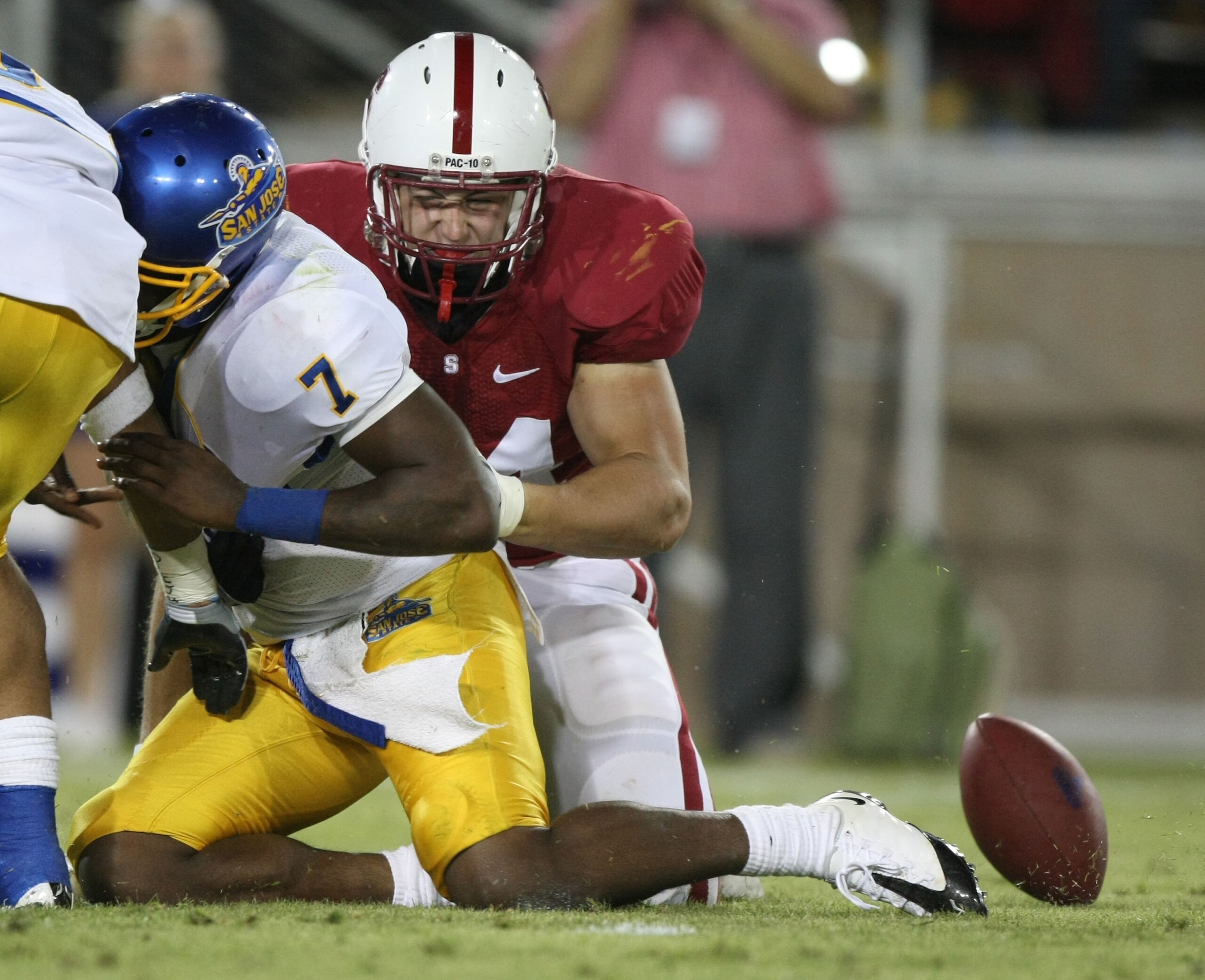 STANFORD, CA - SEPTEMBER 20:  Kyle Reed #7 of San Jose State Spartans fumbles the ball as Tom Keiser #94 of the Stanford Cardinals defends during the fourth quarter at Stanford Stadium on September 20, 2008 in Stanford, California.  (Photo by Jed Jacobsoh