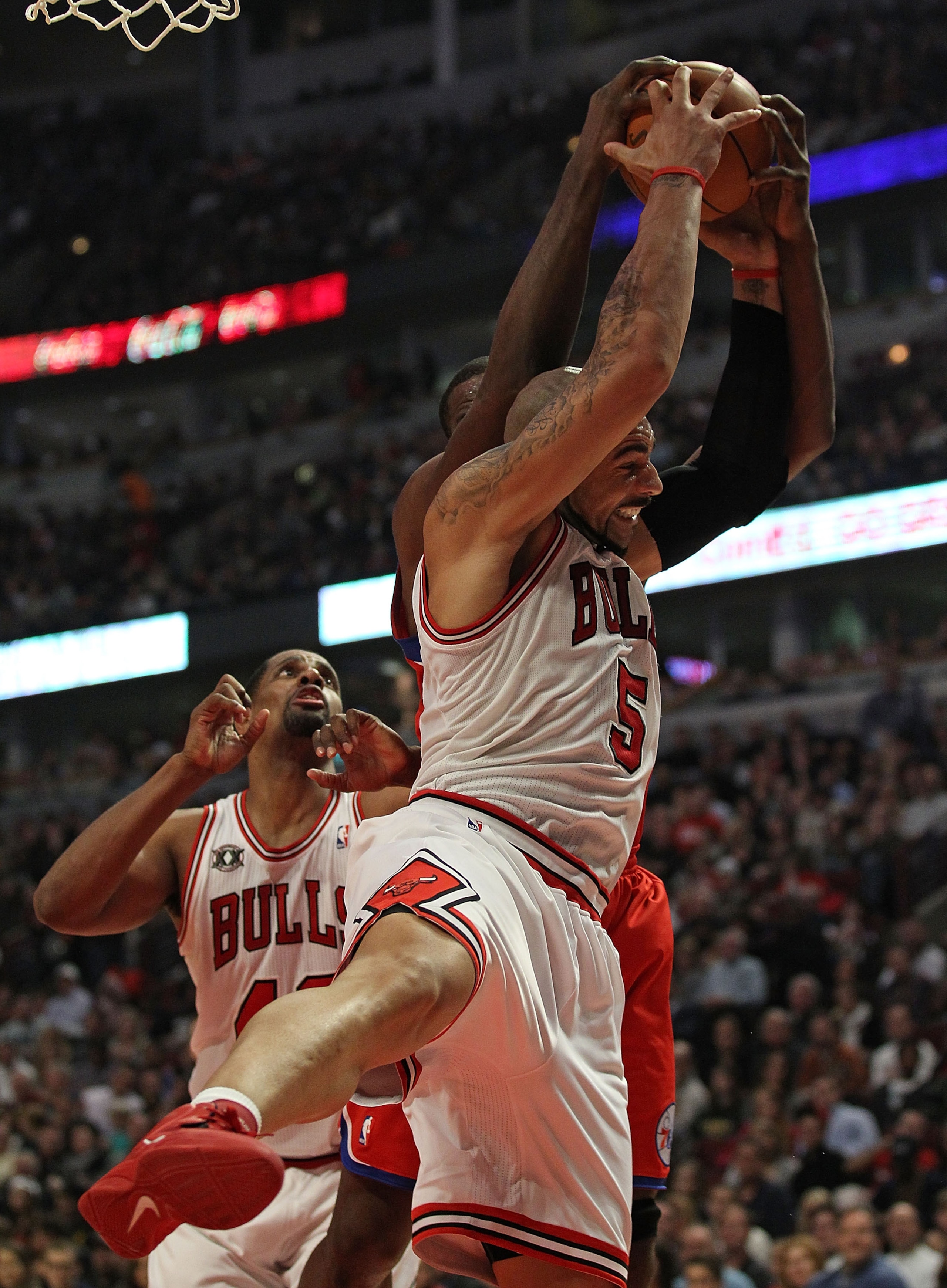 CHICAGO, IL - DECEMBER 21: Carlos Boozer #5 of the Chicago Bulls grabs a rebound from Elton Brand #42 of the Philadelphia 76ers at the United Center on December 21, 2010 in Chicago, Illinois. The Bulls defeated the 76ers 121-76. NOTE TO USER: User express