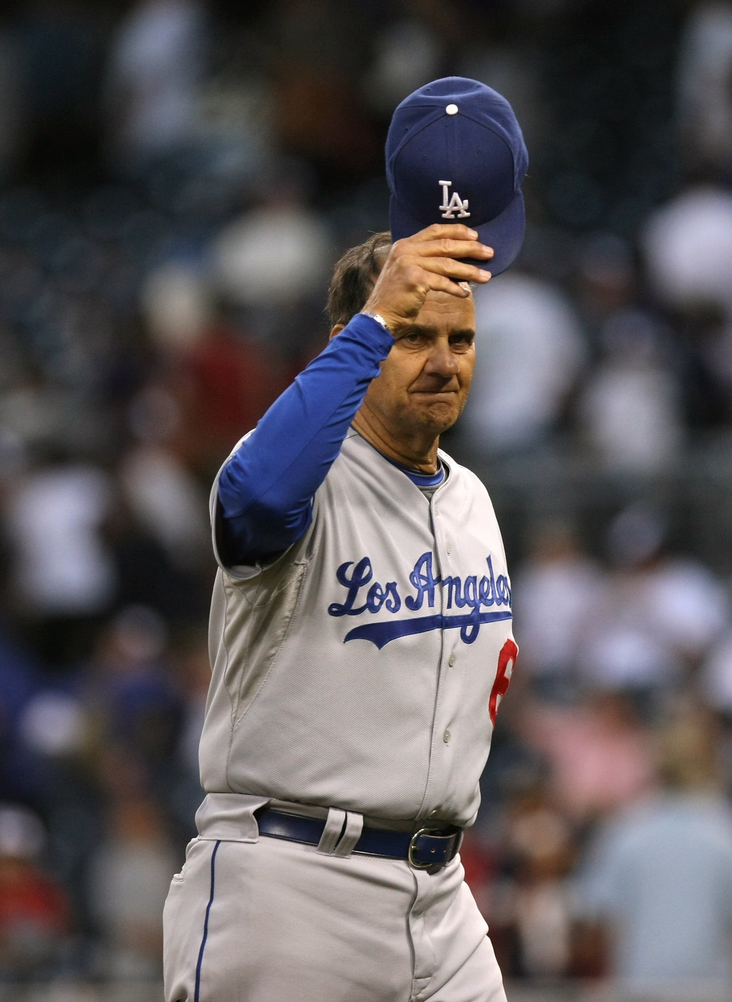 SAN DIEGO - APRIL 06:  Manager Joe Torre of the Los Angeles Dodgers waves his cap as he leves the field after the game with the San Diego Padres on April 6, 2009 at Petco Park in San Diego, California.  The Dodgers won 4-1.  (Photo by Stephen Dunn/Getty I