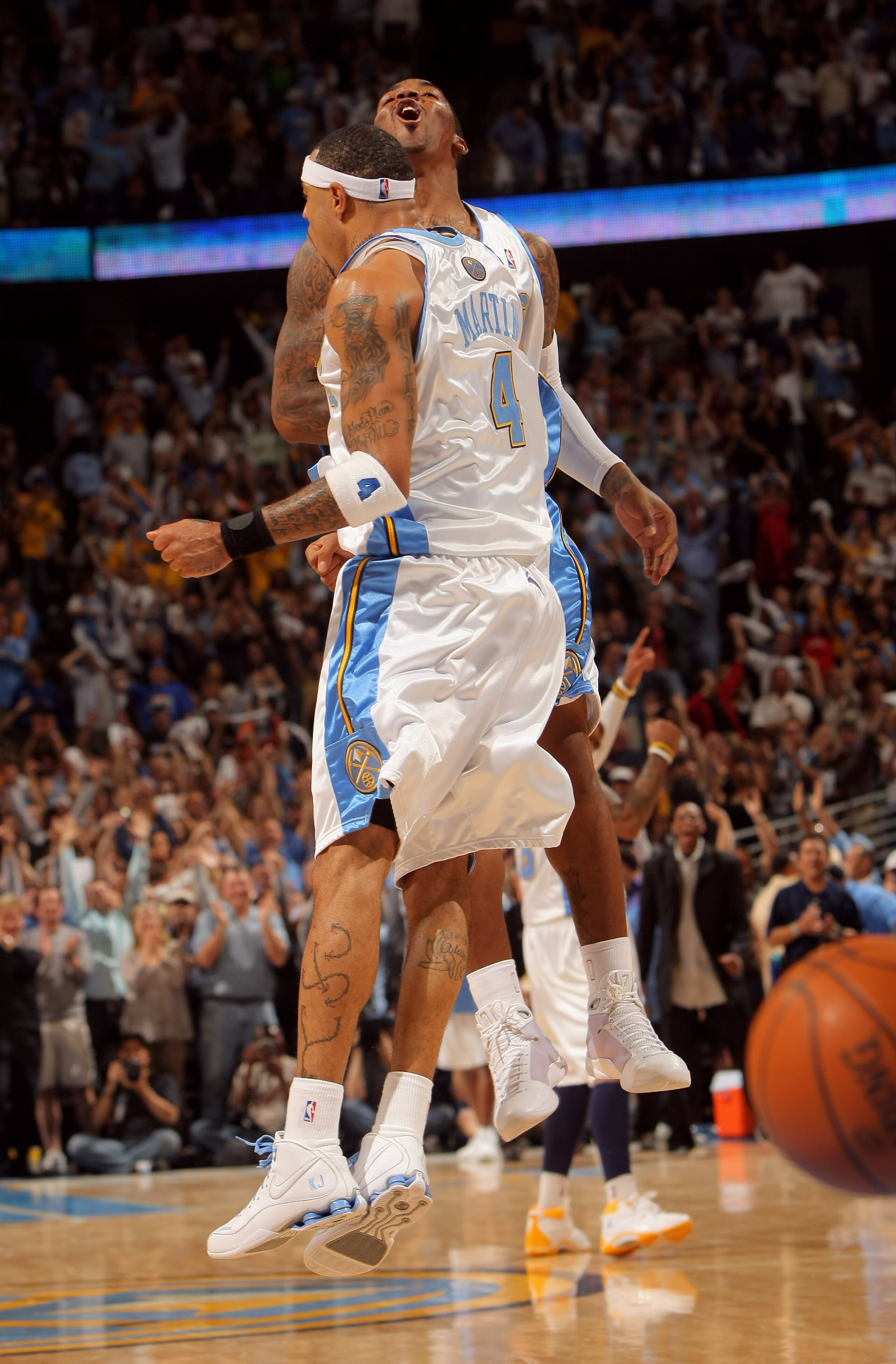 DENVER - MAY 13:  Kenyon Martin #4 and J.R. Smith #1 of the Denver Nuggets celebrate after a play against the Dallas Mavericks late in Game Five of the Western Conference Semifinals during the 2009 NBA Playoffs at Pepsi Center on May 13, 2009 in Denver, C