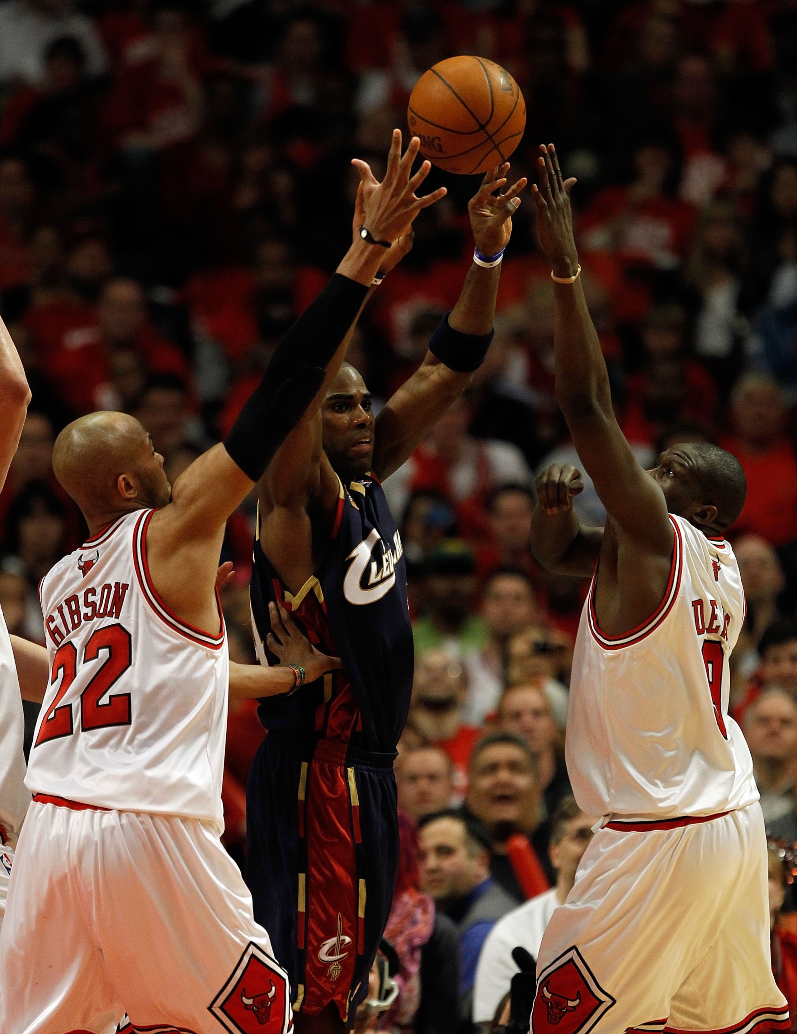 CHICAGO - APRIL 22: Antawn Jamison #4 of the Cleveland Cavaliers passes the ball between Taj Gibson #22 and Luol Deng #9 of the Chicago Bulls in Game Three of the Eastern Conference Quarterfinals during the 2010 NBA Playoffs at the United Center on April CHICAGO - APRIL 22: Antawn Jamison #4 of the Cleveland Cavaliers passes the ball between Taj Gibson #22 and Luol Deng #9 of the Chicago Bulls in Game Three of the Eastern Conference Quarterfinals during the 2010 NBA Playoffs at the United Center on April