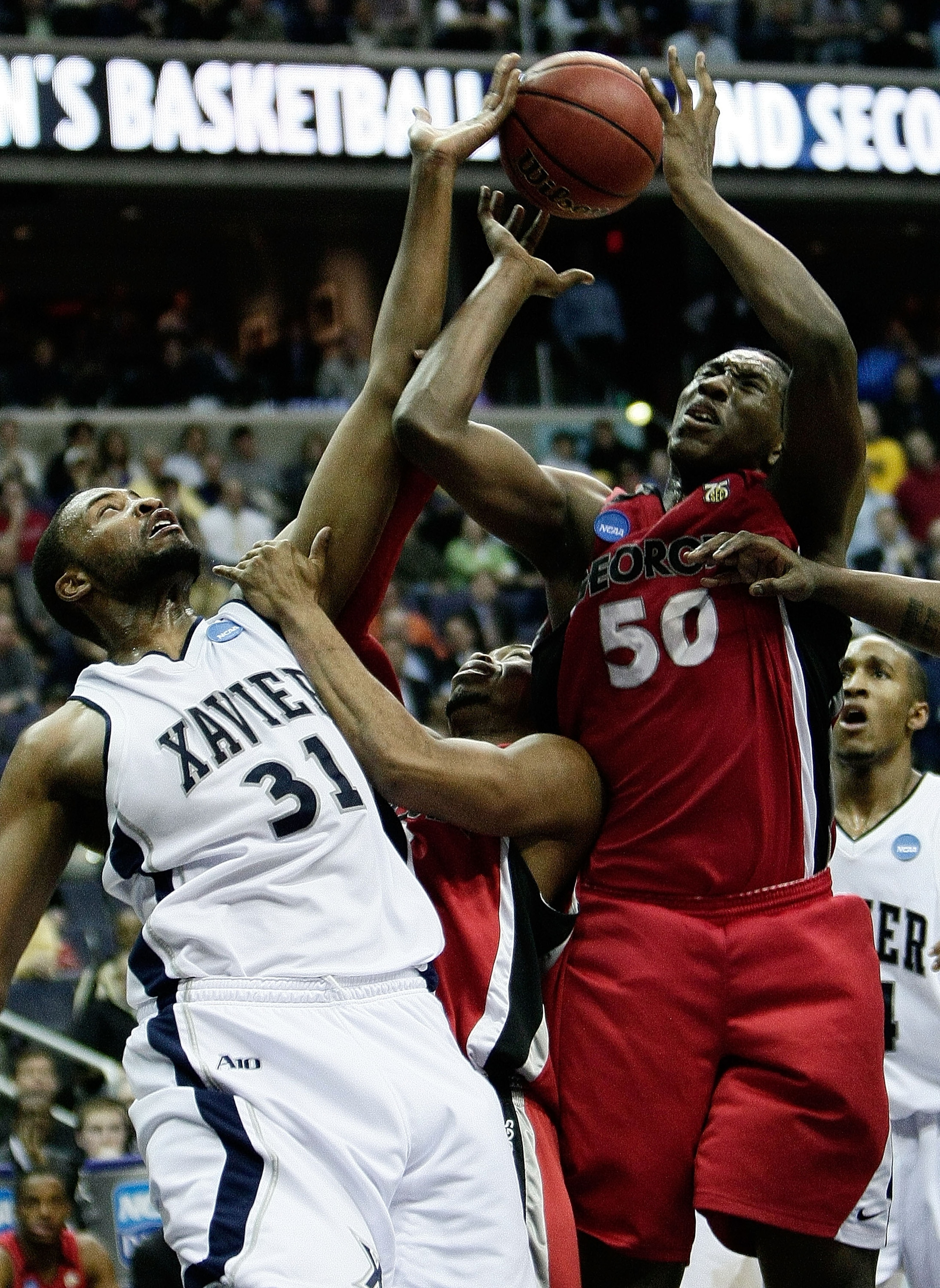 WASHINGTON - MARCH 20: Jason Love #31 of the Xavier Musketeers defends against Jeremy Price #50 of the Georgia Bulldogs during the first round of the West Regional as part of the 2008 NCAA Men's Basketball Tournament at the Verizon Center on March 20, 20 WASHINGTON - MARCH 20: Jason Love #31 of the Xavier Musketeers defends against Jeremy Price #50 of the Georgia Bulldogs during the first round of the West Regional as part of the 2008 NCAA Men's Basketball Tournament at the Verizon Center on March 20, 20