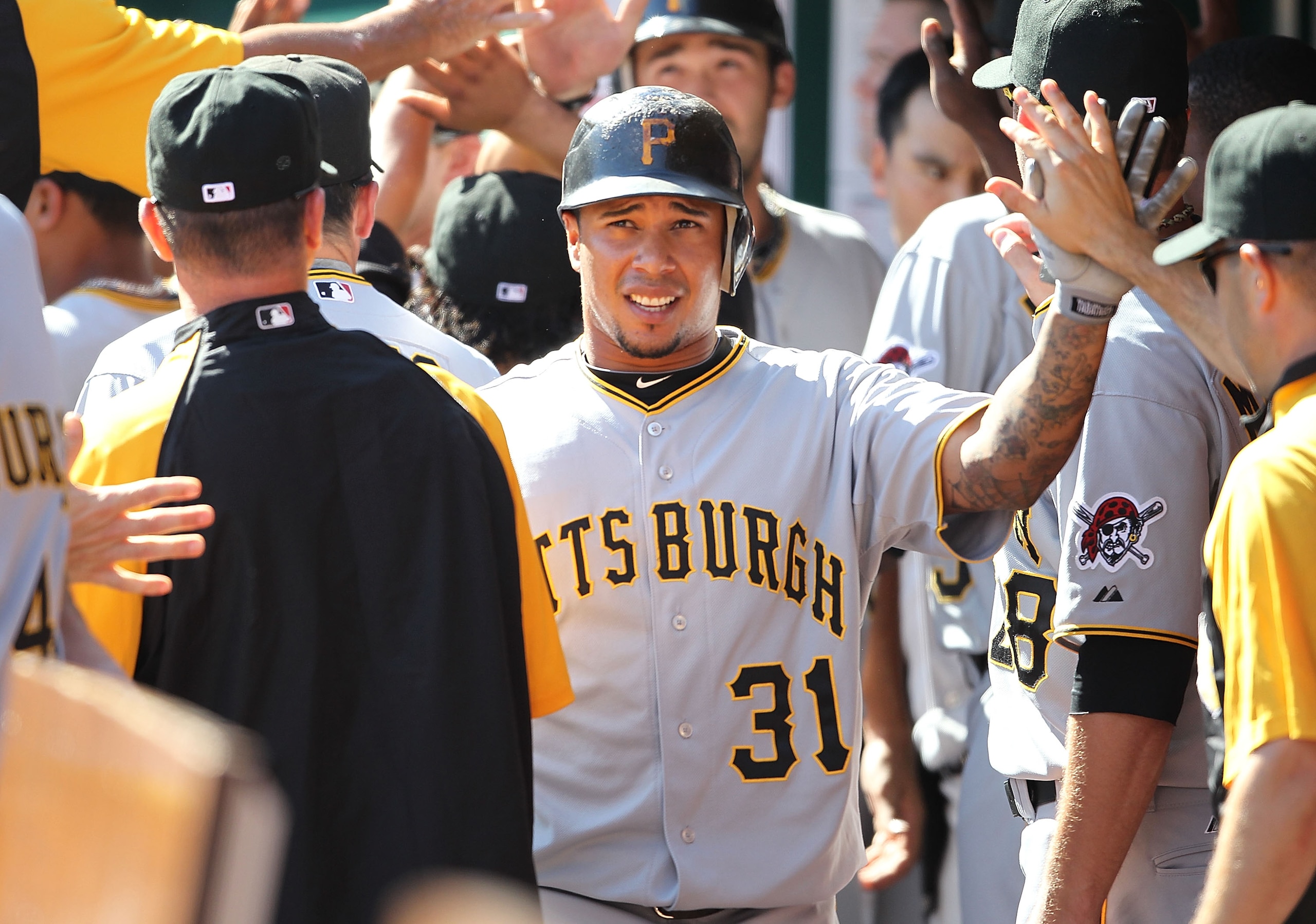 CINCINNATI - SEPTEMBER 12:  Jose Tabata #31 of the Pittsburgh Pirates is congratulated by teammates after scoring one of the three ninth inning runs during the game against the Cincinnati Reds at Great American Ballpark on September 12, 2010 in Cincinnati