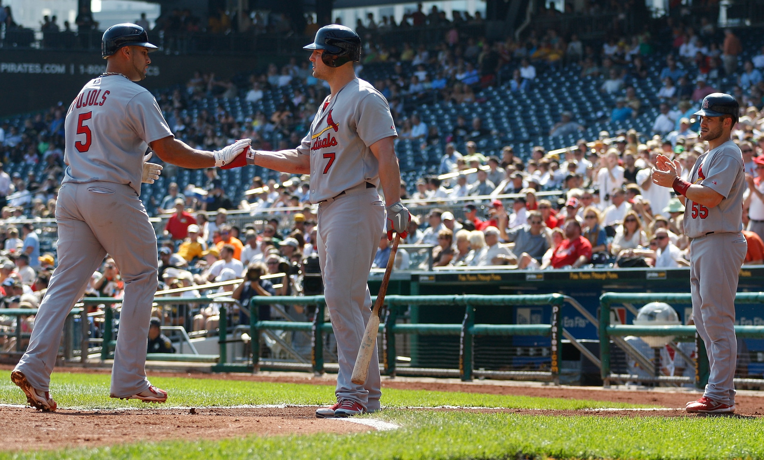 PITTSBURGH - SEPTEMBER 23:  Albert Pujols #5 of the St Louis Cardinals is congratulated by teammate Matt Holliday #7 after hitting a two run home run off of Brian Burres #71 the Pittsburgh Pirates during the game on September 23, 2010 at PNC Park in Pitts