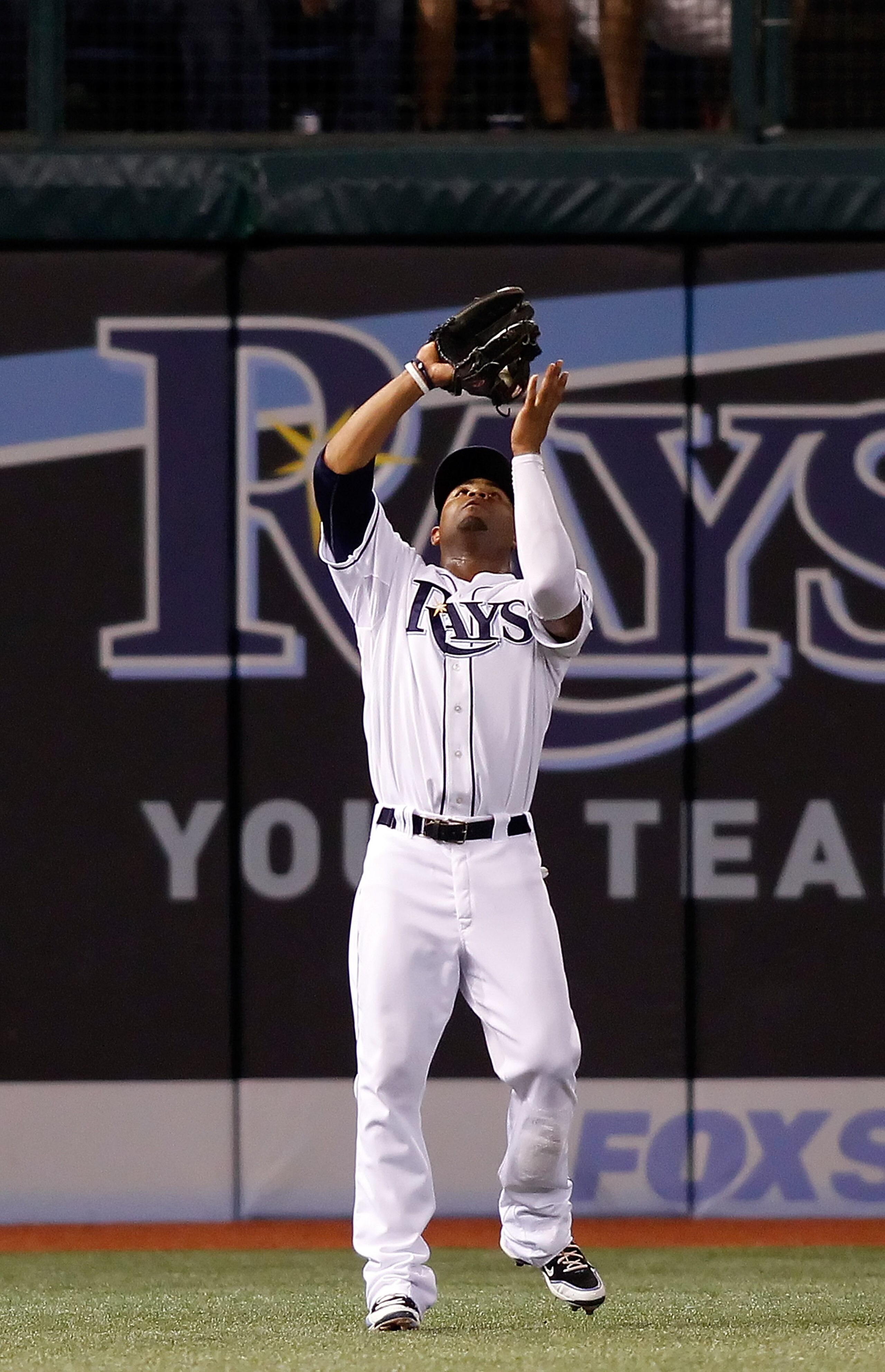 ST. PETERSBURG - SEPTEMBER 13:  Outfielder Carl Crawford #13 of the Tampa Bay Rays catches a fly ball against the New York Yankees during the game at Tropicana Field on September 13, 2010 in St. Petersburg, Florida.  (Photo by J. Meric/Getty Images)