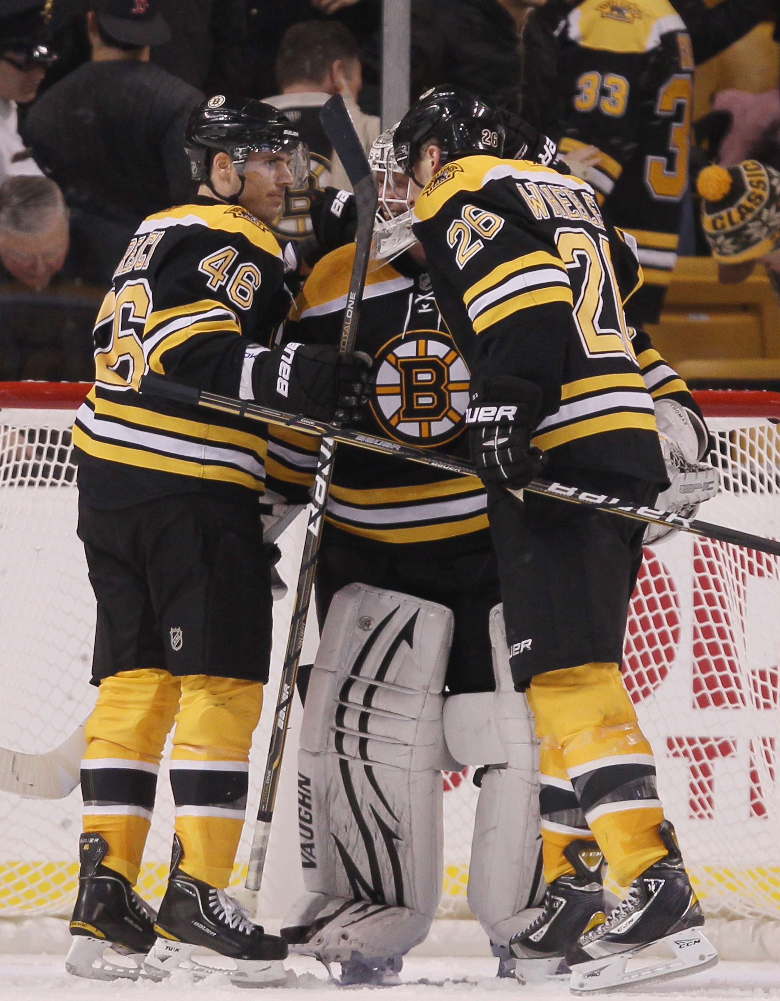 BOSTON, MA - DECEMBER 18:  Tim Thomas #30 of the Boston Bruins is congratulated by teammates David Krejci #46 and Blake Wheeler #26 after the game against the Washington Captials on December 18, 2010 at the TD Garden in Boston, Massachusetts. The Bruins d