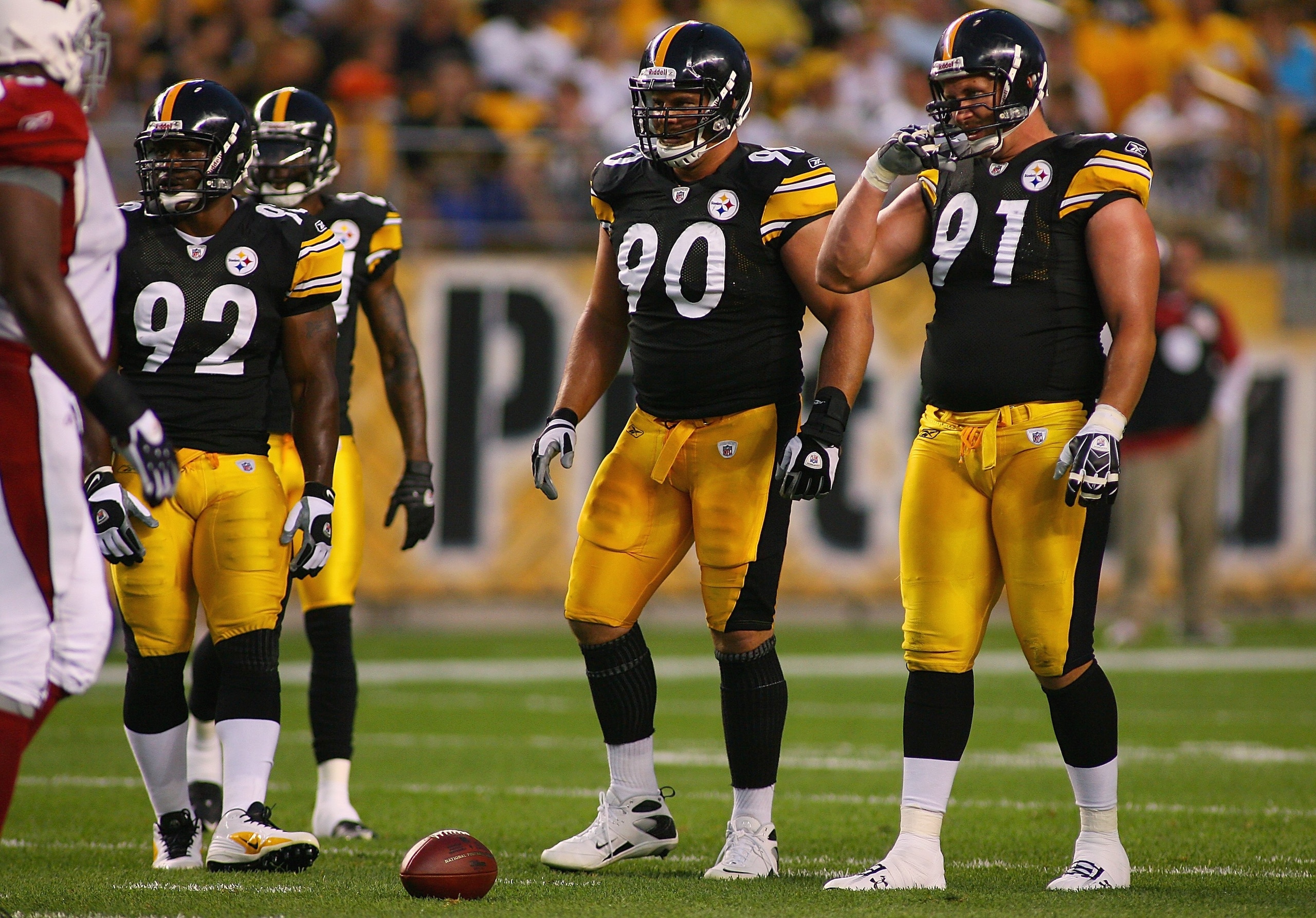 PITTSBURGH - AUGUST 13: (L-R) James Harrison #92, Travis Kirschke #90, and Aaron Smith #91 of the Pittsburgh Steelers stand at the line of scrimmage during the preseason NFL game against the Arizona Cardinals at Heinz Field on August 13, 2009 in Pittsbur PITTSBURGH - AUGUST 13: (L-R) James Harrison #92, Travis Kirschke #90, and Aaron Smith #91 of the Pittsburgh Steelers stand at the line of scrimmage during the preseason NFL game against the Arizona Cardinals at Heinz Field on August 13, 2009 in Pittsbur