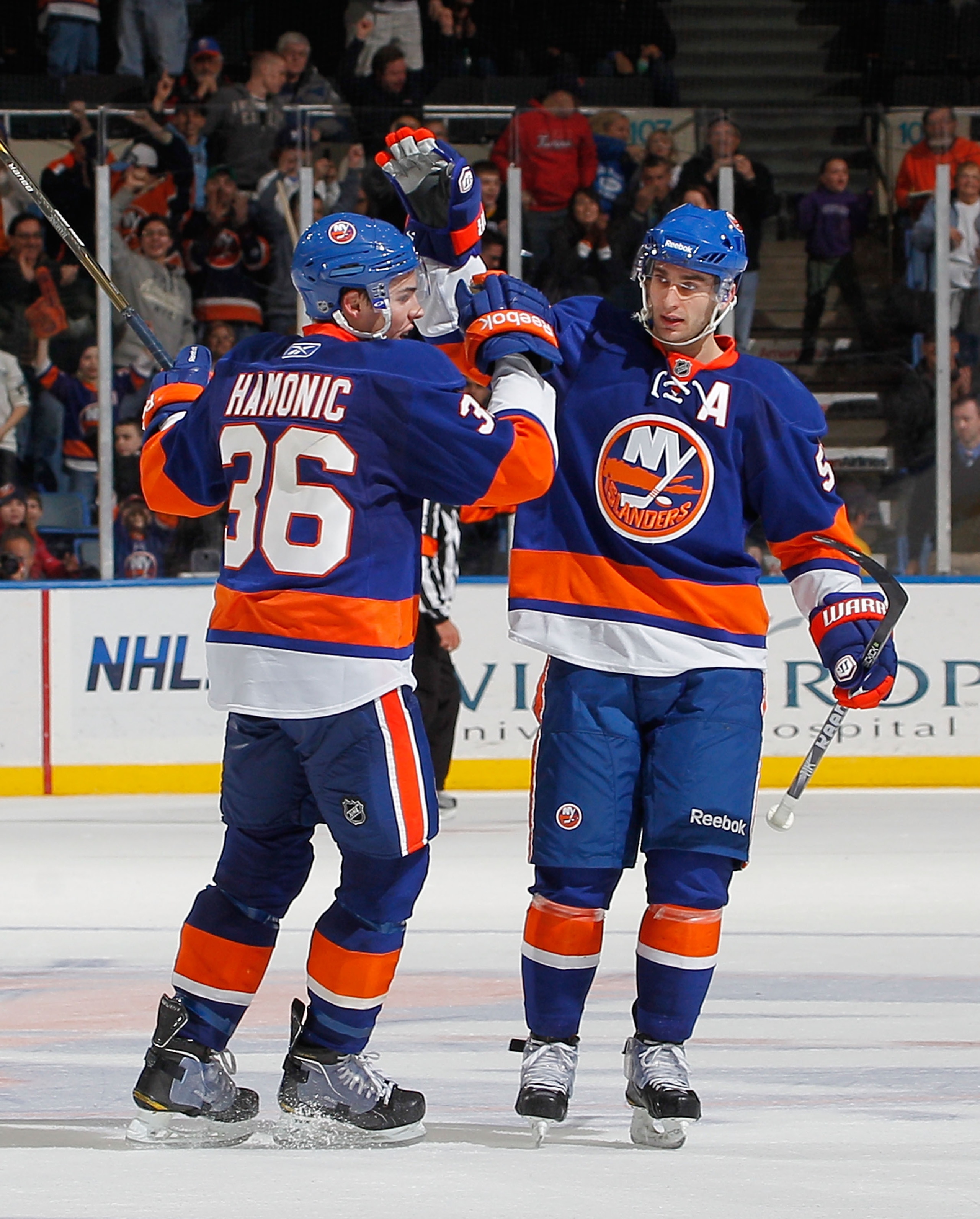 UNIONDALE, NY - FEBRUARY 05:  Travis Hamonic #36 and Frans Nielsen #51 of the New York Islanders celebrate Nielsen's short handed goal that sealed the Islanders win in an NHL hockey game against the Ottawa Senators at Nassau Coliseum on February 5, 2011 i