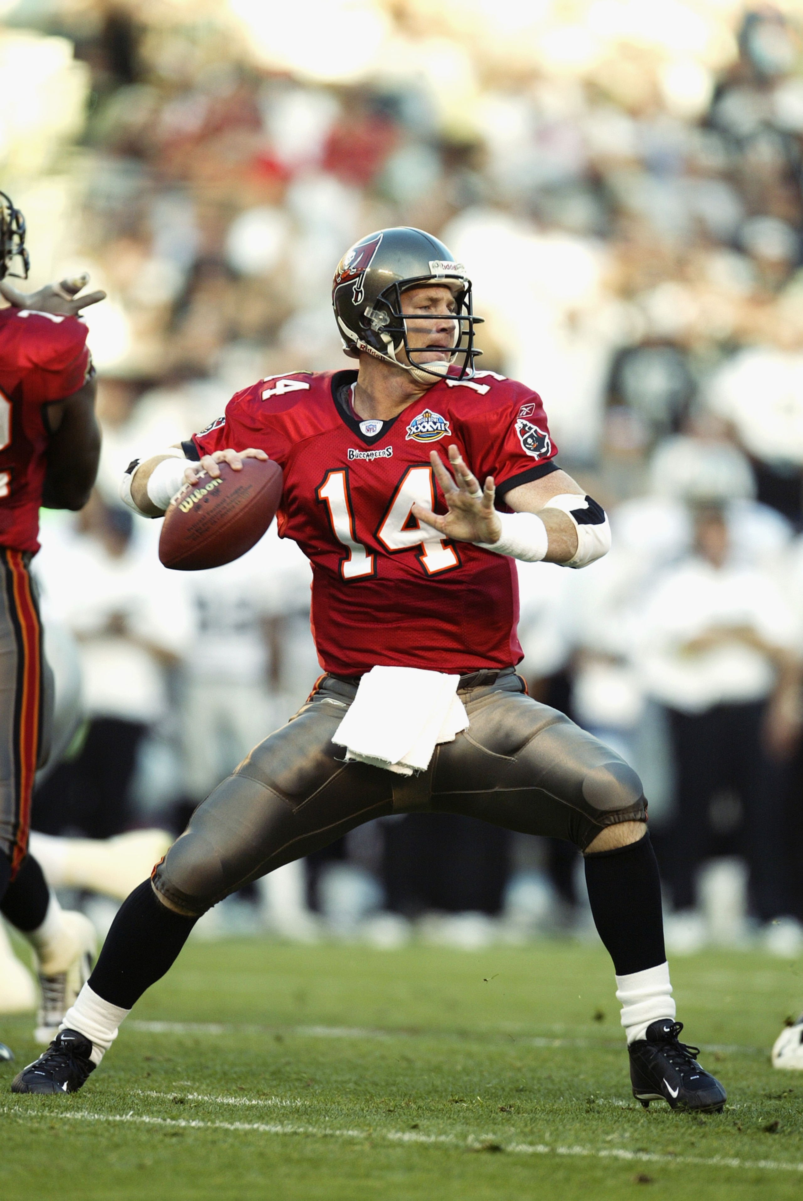 SAN DIEGO - JANUARY 26:  Quarterback Brad Johnson #14 of the Tampa Bay Buccaneers looks for a receiver during Super Bowl XXXVII against the Oakland Raiders at Qualcomm Stadium on January 26, 2003 in San Diego, California.  The Buccaneers defeated the Raid