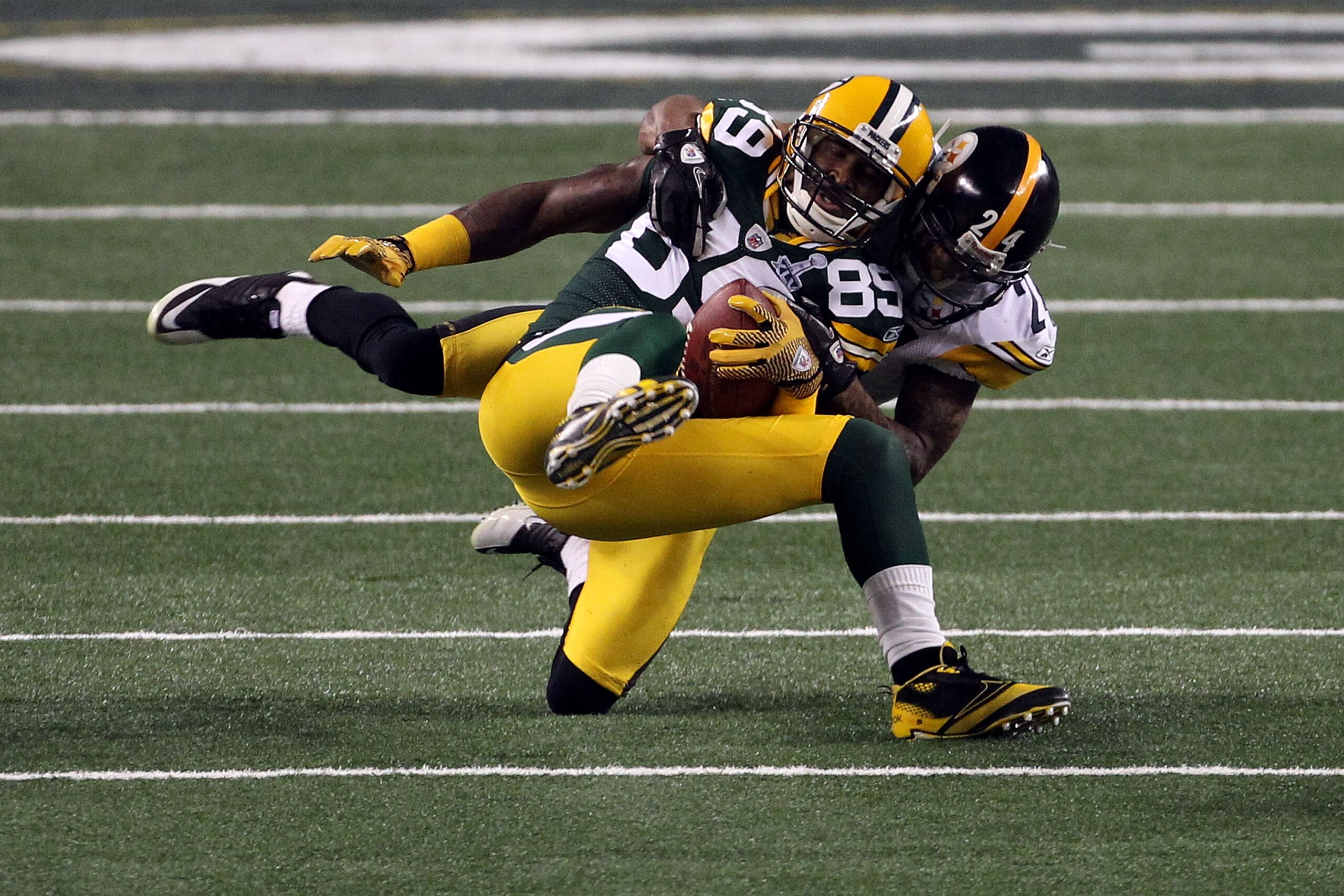 ARLINGTON, TX - FEBRUARY 06: James Jones #89 of the Green Bay Packers is tackled after a catch by Ike Taylor #24 of the Pittsburgh Steelers during Super Bowl XLV at Cowboys Stadium on February 6, 2011 in Arlington, Texas. (Photo by Streeter Lecka/Getty I ARLINGTON, TX - FEBRUARY 06: James Jones #89 of the Green Bay Packers is tackled after a catch by Ike Taylor #24 of the Pittsburgh Steelers during Super Bowl XLV at Cowboys Stadium on February 6, 2011 in Arlington, Texas. (Photo by Streeter Lecka/Getty I