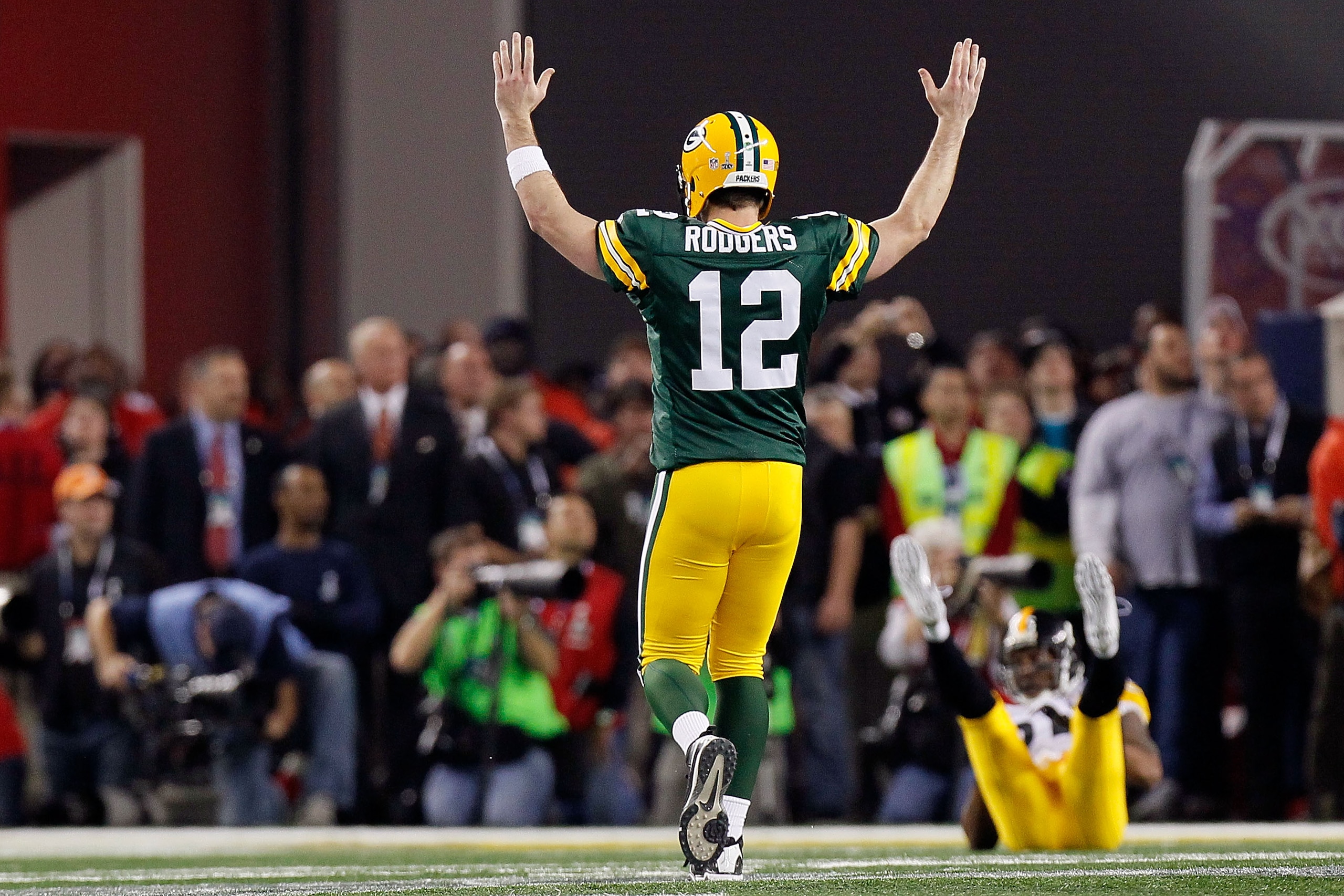 ARLINGTON, TX - FEBRUARY 06: Aaron Rodgers #12 of the Green Bay Packers celebrates after a touchdown pass to Greg Jennings against the Pittsburgh Steelers during Super Bowl XLV at Cowboys Stadium on February 6, 2011 in Arlington, Texas.  (Photo by Kevin C
