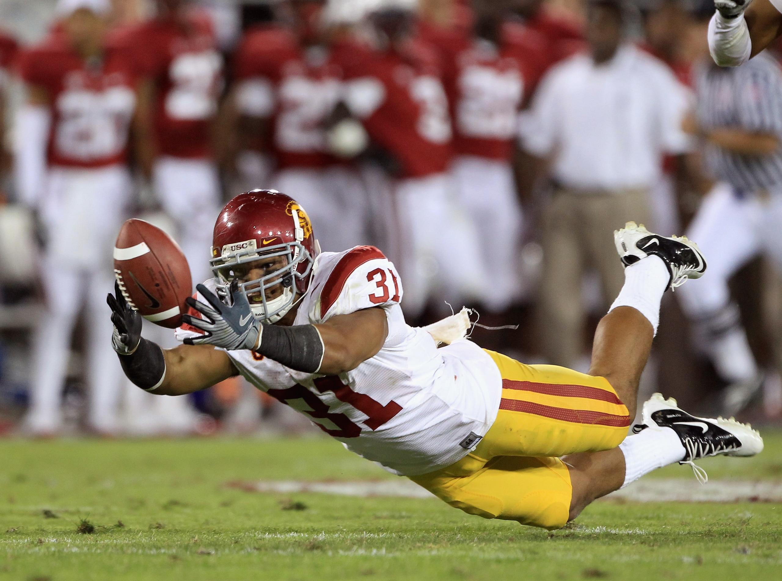 PALO ALTO, CA - OCTOBER 09:  Stanley Havili #31 of the USC Trojans dives for the ball during their game against the Stanford Cardinal at Stanford Stadium on October 9, 2010 in Palo Alto, California.  (Photo by Ezra Shaw/Getty Images)