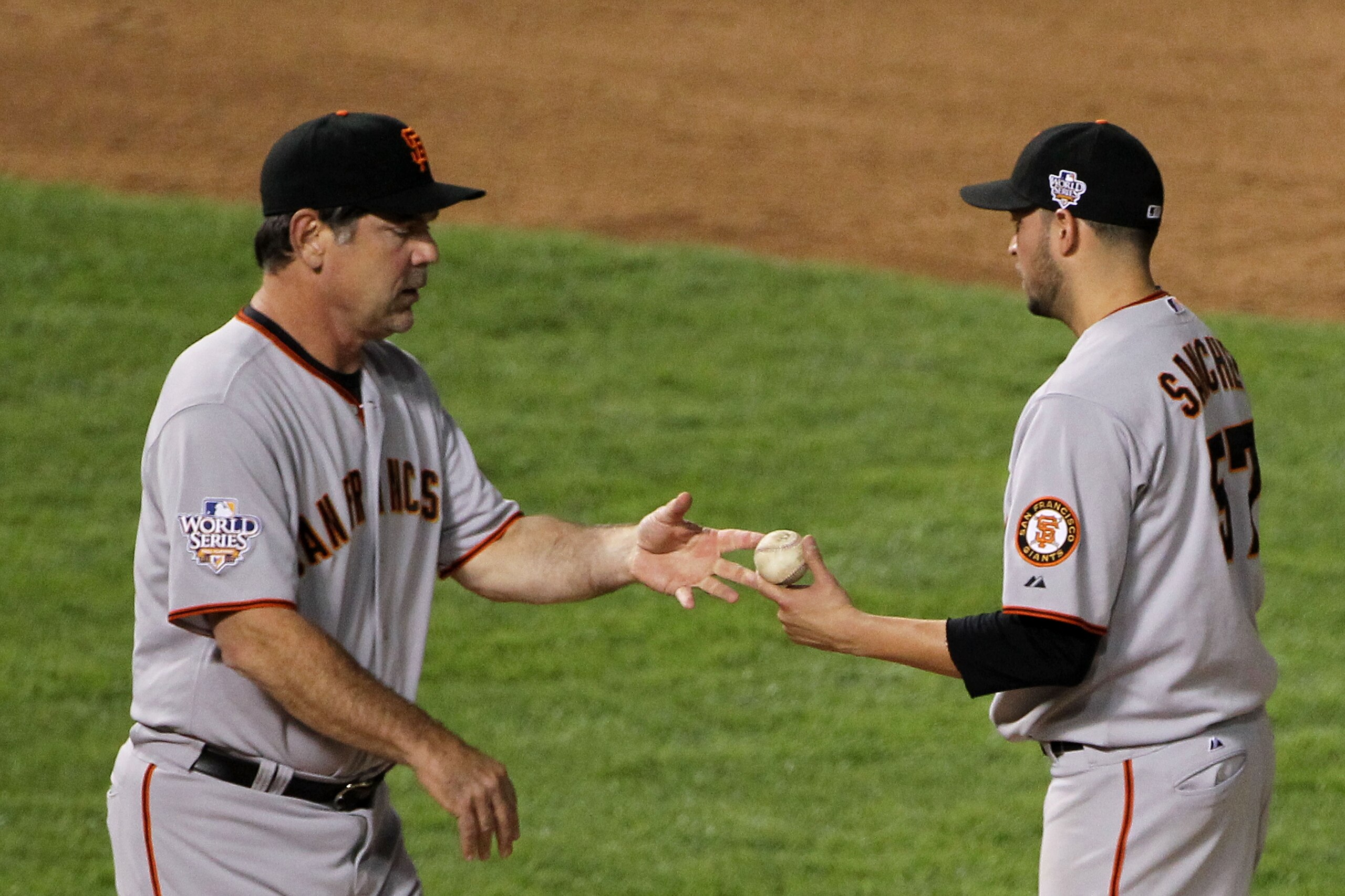 ARLINGTON, TX - OCTOBER 30:  Starting pitcher Jonathan Sanchez #57 of the San Francisco Giants hands the ball to manager Bruce Bochy after he was taken out of the game in the bottom of the fifth inning against the Texas Rangers in Game Three of the 2010 M