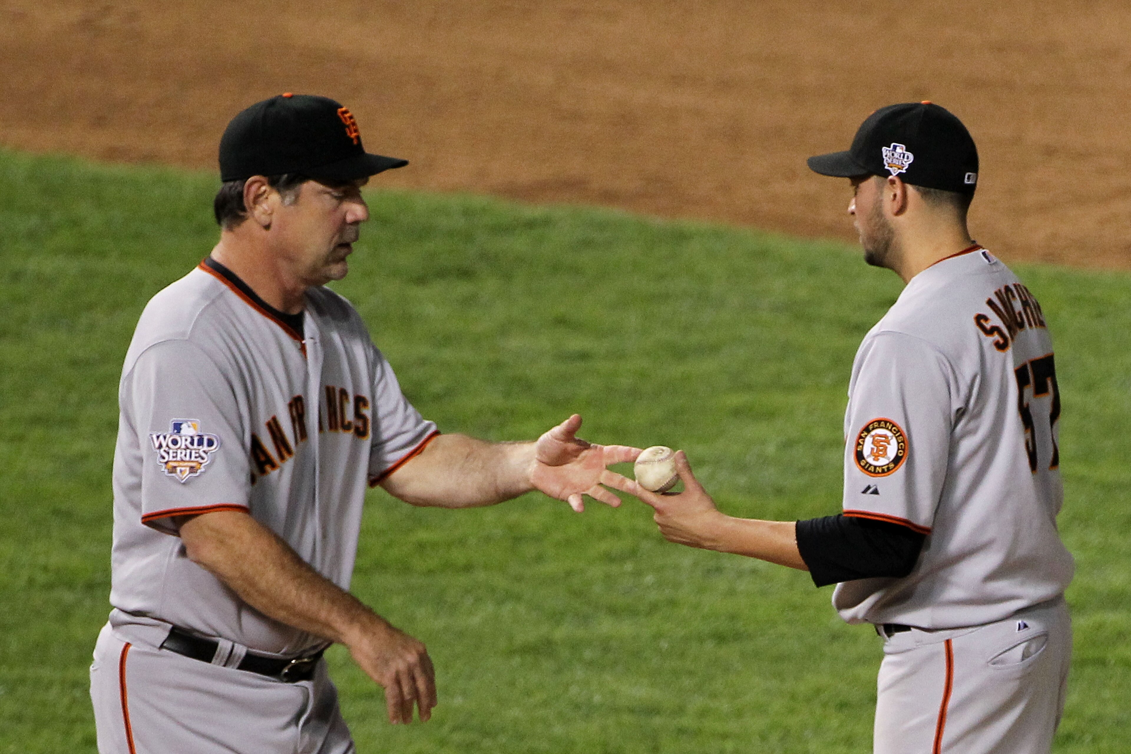 ARLINGTON, TX - OCTOBER 30:  Starting pitcher Jonathan Sanchez #57 of the San Francisco Giants hands the ball to manager Bruce Bochy after he was taken out of the game in the bottom of the fifth inning against the Texas Rangers in Game Three of the 2010 M