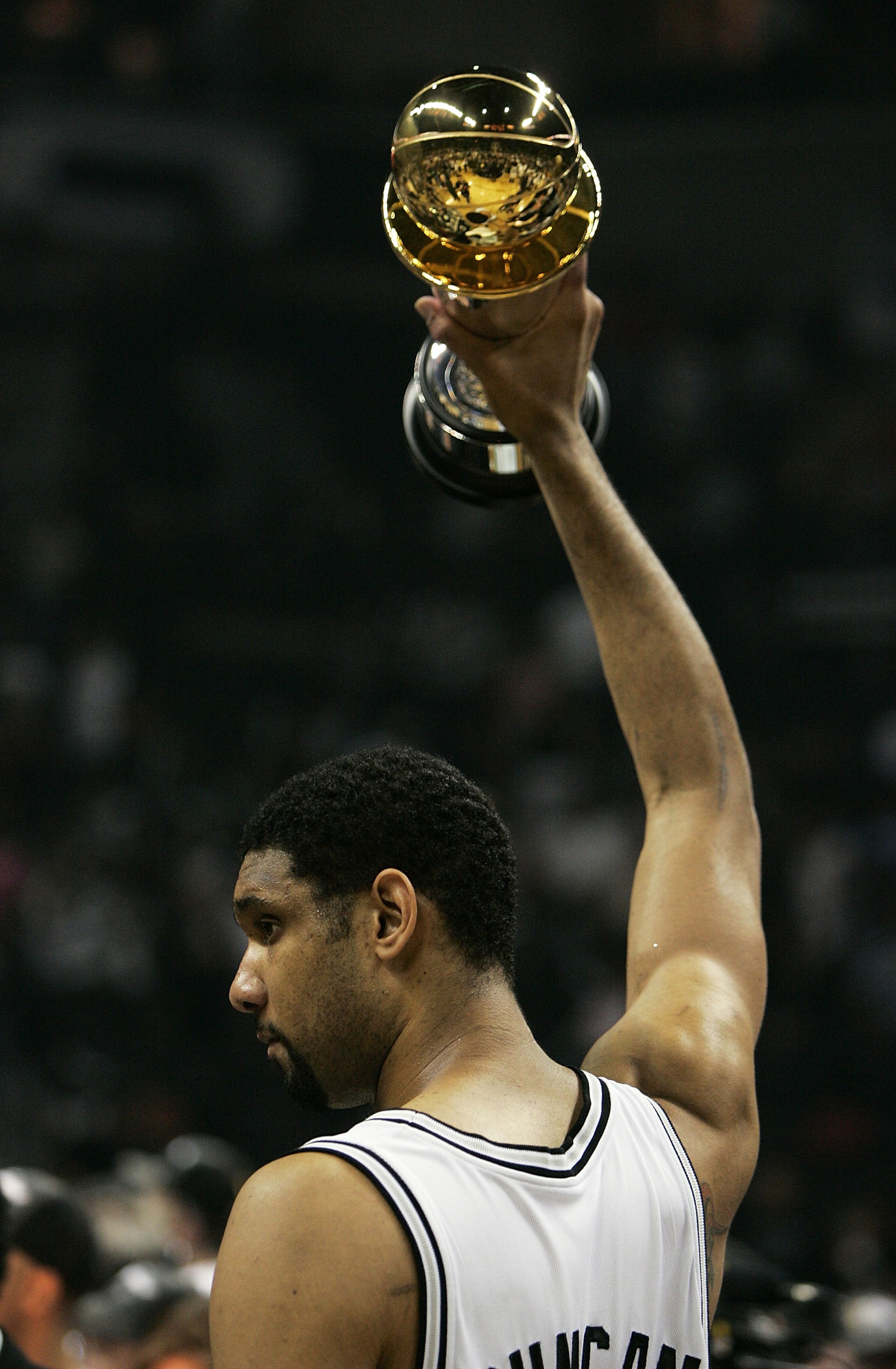 SAN ANTONIO - JUNE 23:  Tim Duncan #21 of the San Antonio Spurs celebrates with the Finals MVP Trophy after defeating the Detroit Pistons in Game seven of the 2005 NBA Finals at SBC Center on June 23, 2005 in San Antonio, Texas. The Spurs defeated the Pis