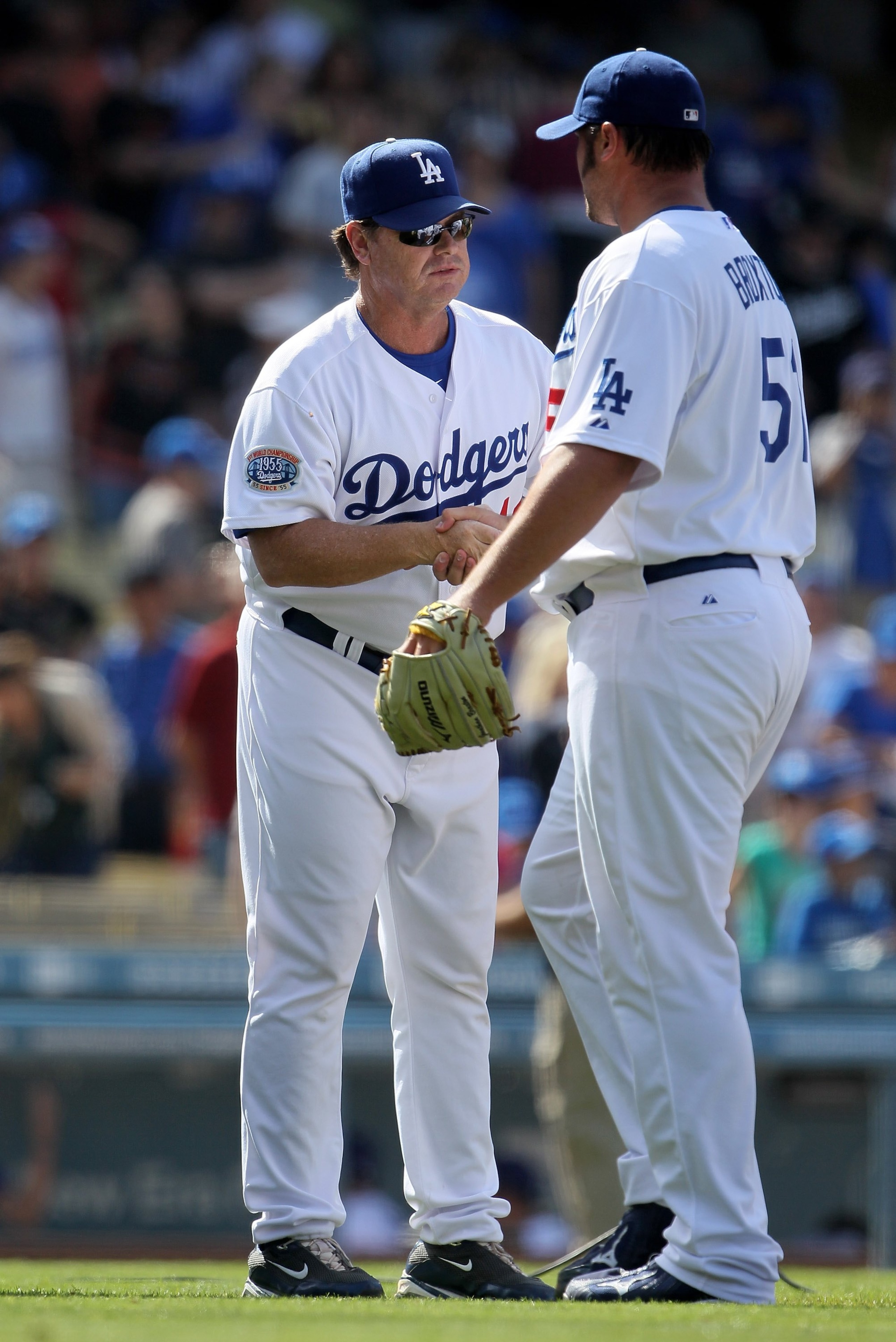 LOS ANGELES, CA - APRIL 18:  Pitching coach Rick Honeycutt #40 of the Los Angeles Dodgers congratulates Jonathan Broxton #51 against the San Francisco Giants at Dodger Stadium on April 18, 2010 in Los Angeles, California. The Dodgers defeated the Giants 2