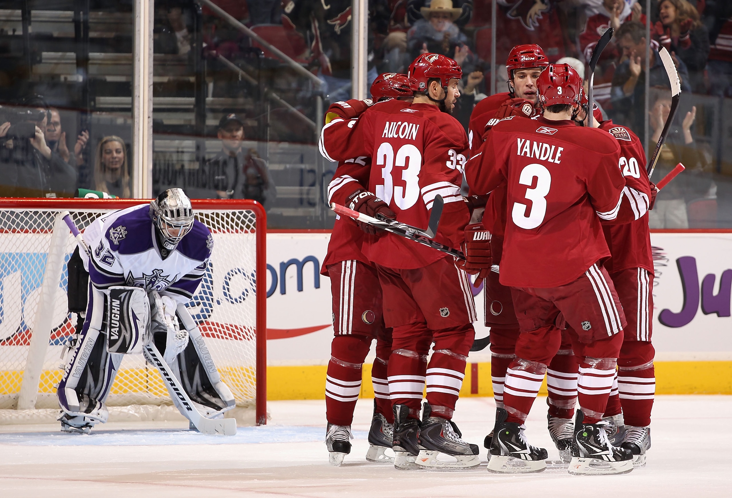 GLENDALE, AZ - JANUARY 22:  Adrian Aucoin #33, Taylor Pyatt #14 and Keith Yandle #3 of the Phoenix Coyotes celebrate after scoring against goaltender Jonathan Quick #32 of the Los Angeles Kings during the NHL game at Jobing.com Arena on January 22, 2011 i