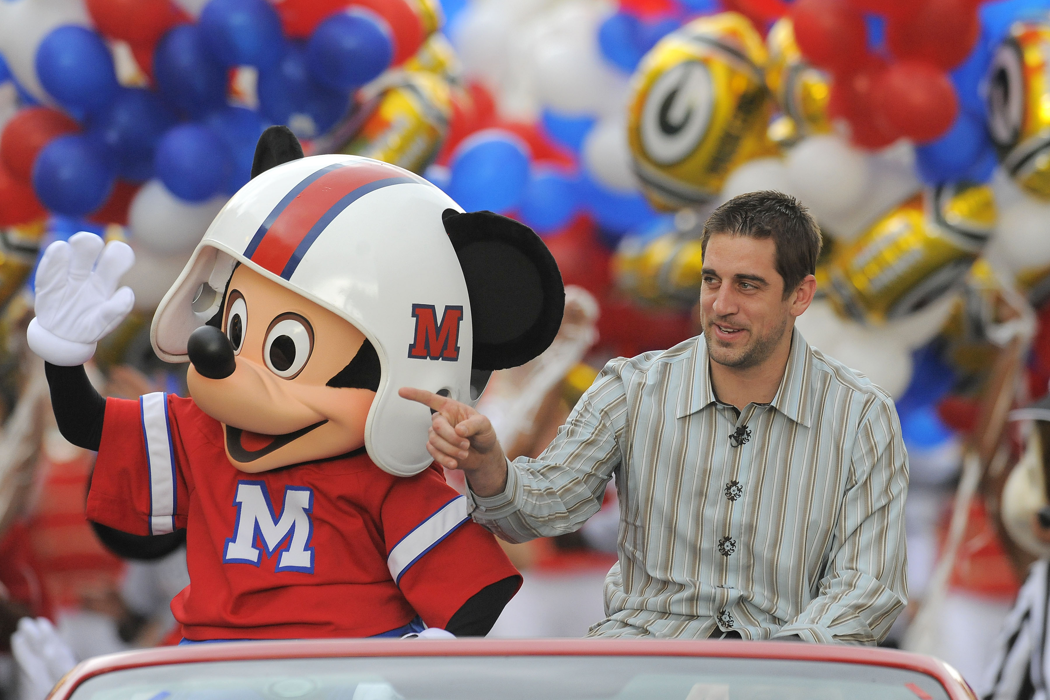 LAKE BUENA VISTA, FL - FEBRUARY 07: In this handout photo provided by Disney, Super Bowl XLV Most Valuable Player Aaron Rodgers takes a celebratory ride with Mickey Mouse, following the Green Bay Packers' 31-25 victory over the Pittsburgh Steelers Februa