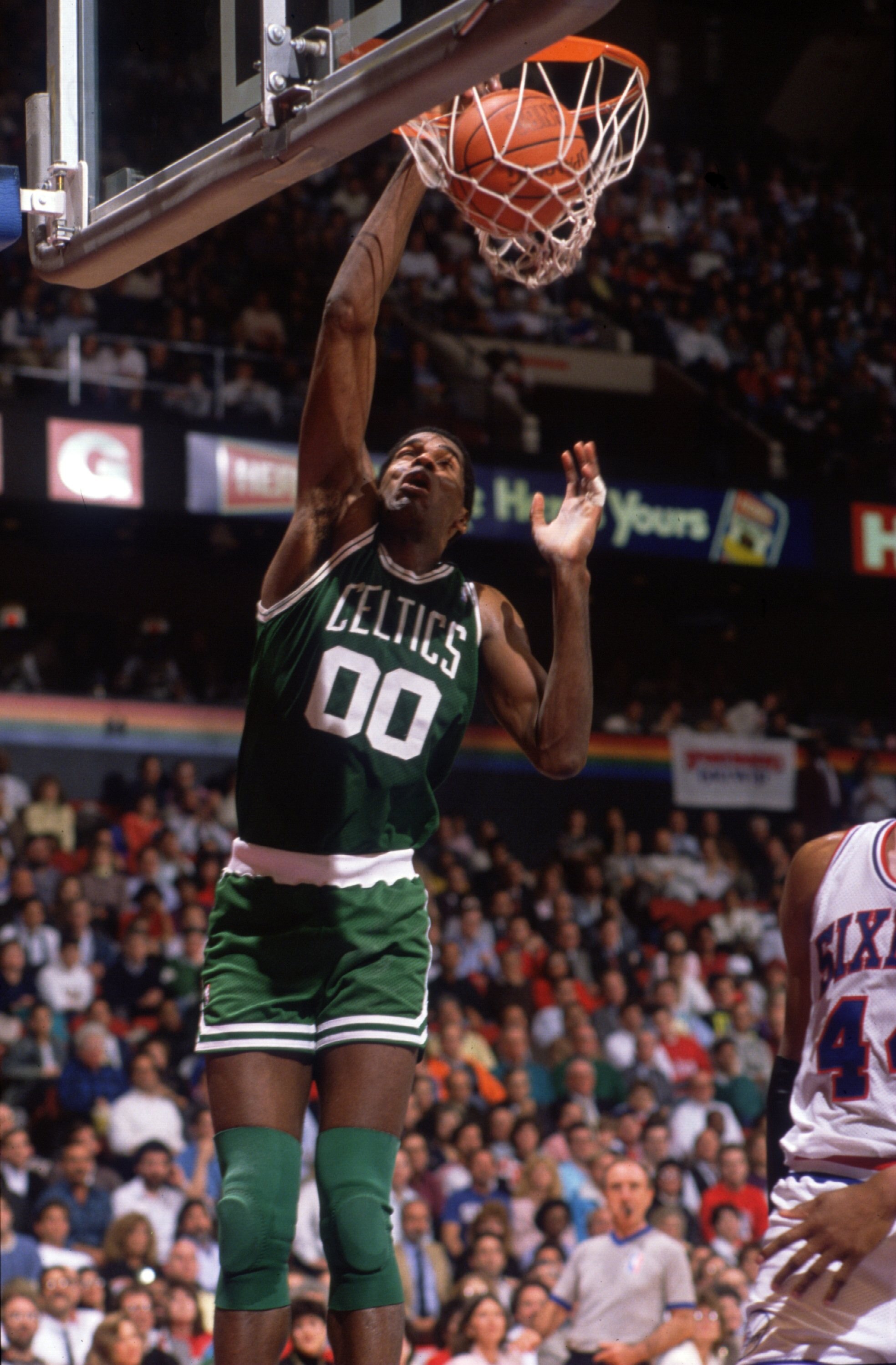 1990:  Center Robert Parish #00 of the Boston Celtics focuses on the rim as he leaps for a slam dunk during a Celtics game against the Philadelphia 76ers at the Spectrum in Philadelphia, Pennsylvania.   Mandatory Credit: Allsport USA/ALLSPORT