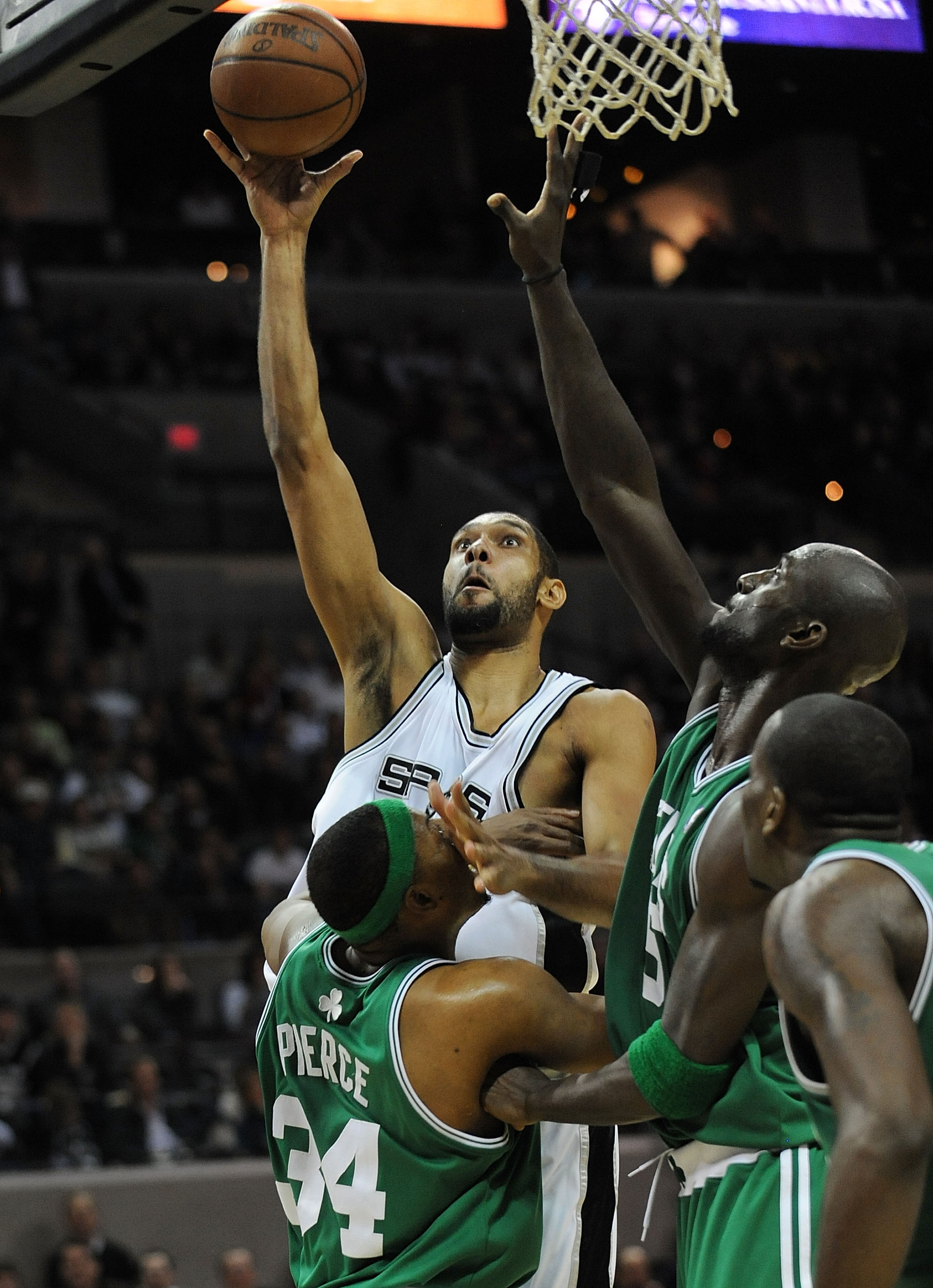 SAN ANTONIO - DECEMBER 03:  Forward Tim Duncan #21 of the San Antonio Spurs takes a shot against Paul Pierce #34 and Kevin Garnett #5 of the Boston Celtics on December 3, 2009 at AT&T Center in San Antonio, Texas.  NOTE TO USER: User expressly acknowledge