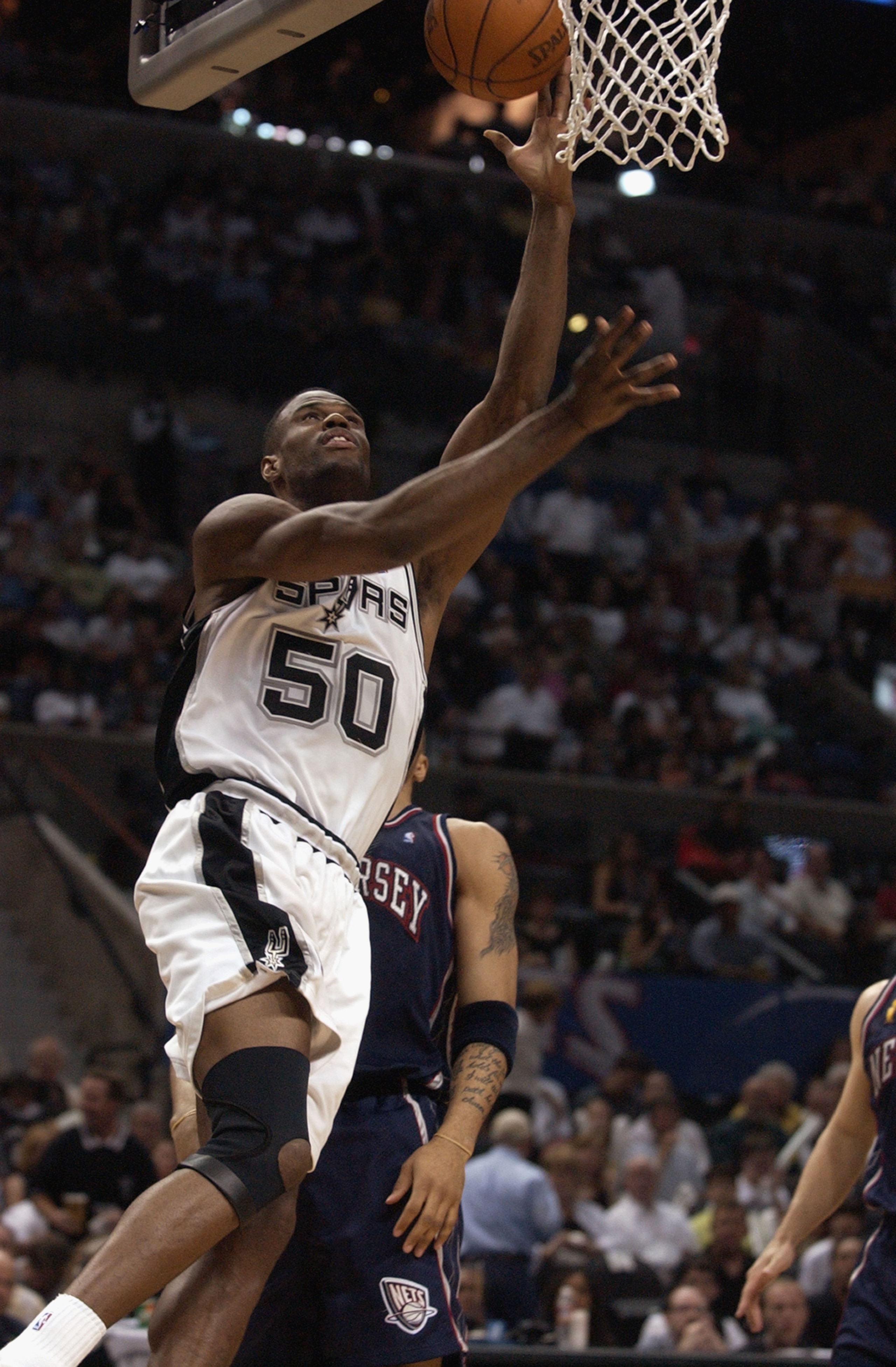 SAN ANTONIO - JUNE 6: David Robinson #50 of the San Antonio Spurs shoots a layup during Game two of the 2003 NBA Finals against the New Jersey Nets at SBC Center on June 6, 2003 in San Antonio, Texas. The Nets won 87-85. NOTE TO USER: User expressly ac SAN ANTONIO - JUNE 6: David Robinson #50 of the San Antonio Spurs shoots a layup during Game two of the 2003 NBA Finals against the New Jersey Nets at SBC Center on June 6, 2003 in San Antonio, Texas. The Nets won 87-85. NOTE TO USER: User expressly ac