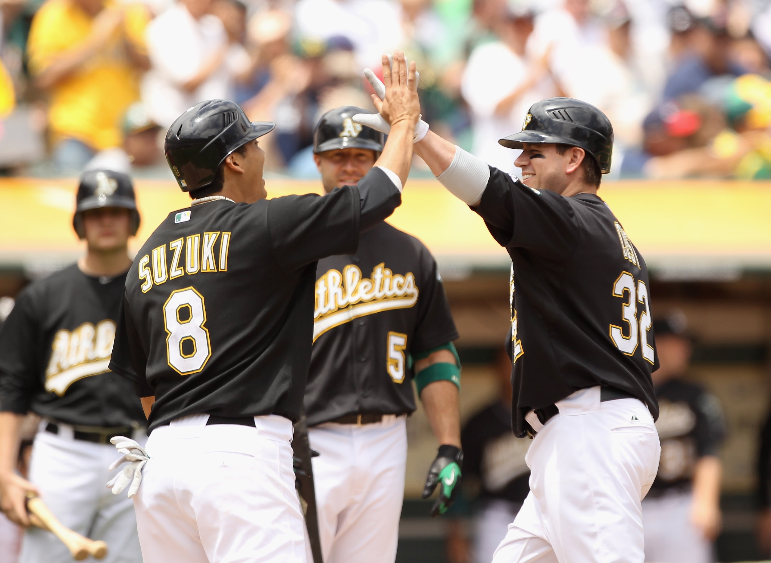 OAKLAND, CA - JULY 21:  Jack Cust #32 of the Oakland Athletics is congratulated by teammates after he hit a home run off Clay Buchholz #11 of the Boston Red Sox  in the third inning at the Oakland-Alameda County Coliseum on July 21, 2010 in Oakland, Calif