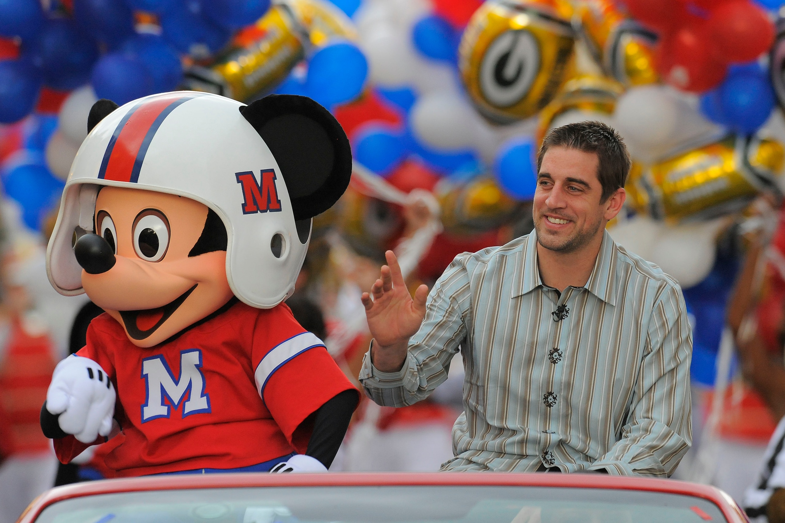 LAKE BUENA VISTA, FL - FEBRUARY 07:  In this handout photo provided by Disney, Super Bowl XLV Most Valuable Player Aaron Rodgers takes a celebratory ride with Mickey Mouse, following the Green Bay Packers' 31-25 victory over the Pittsburgh Steelers Februa