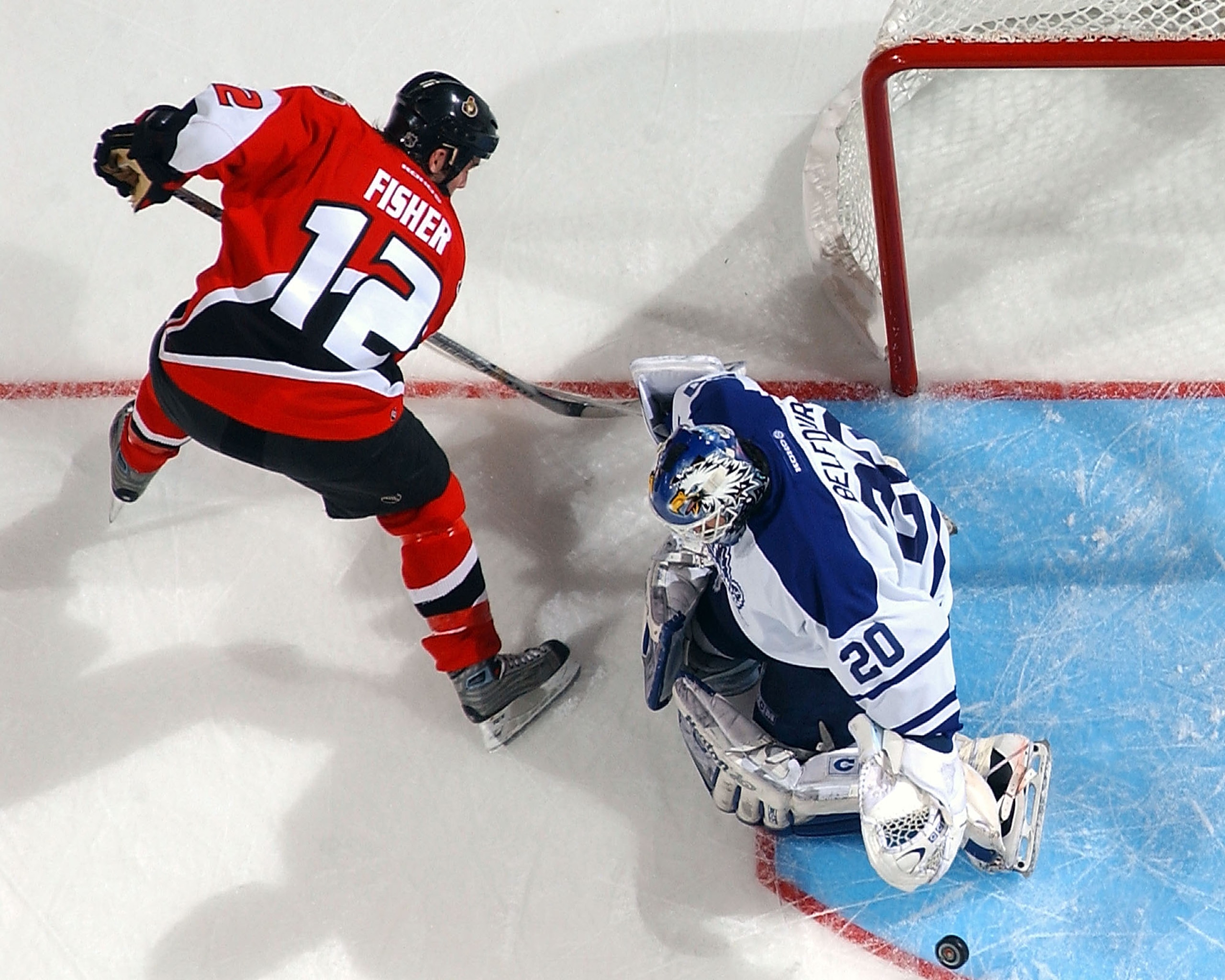 KANATA, ON - APRIL 18: Ed Belfour #20 of the Toronto Maple Leafs makes a save on Mike Fischer #12 of the Ottawa Senators during game six of the Eastern Conference Quarterfinals at the Corel Centre on April 18, 2004 in Kanata, Ontario. (Photo By Dave San KANATA, ON - APRIL 18: Ed Belfour #20 of the Toronto Maple Leafs makes a save on Mike Fischer #12 of the Ottawa Senators during game six of the Eastern Conference Quarterfinals at the Corel Centre on April 18, 2004 in Kanata, Ontario. (Photo By Dave San